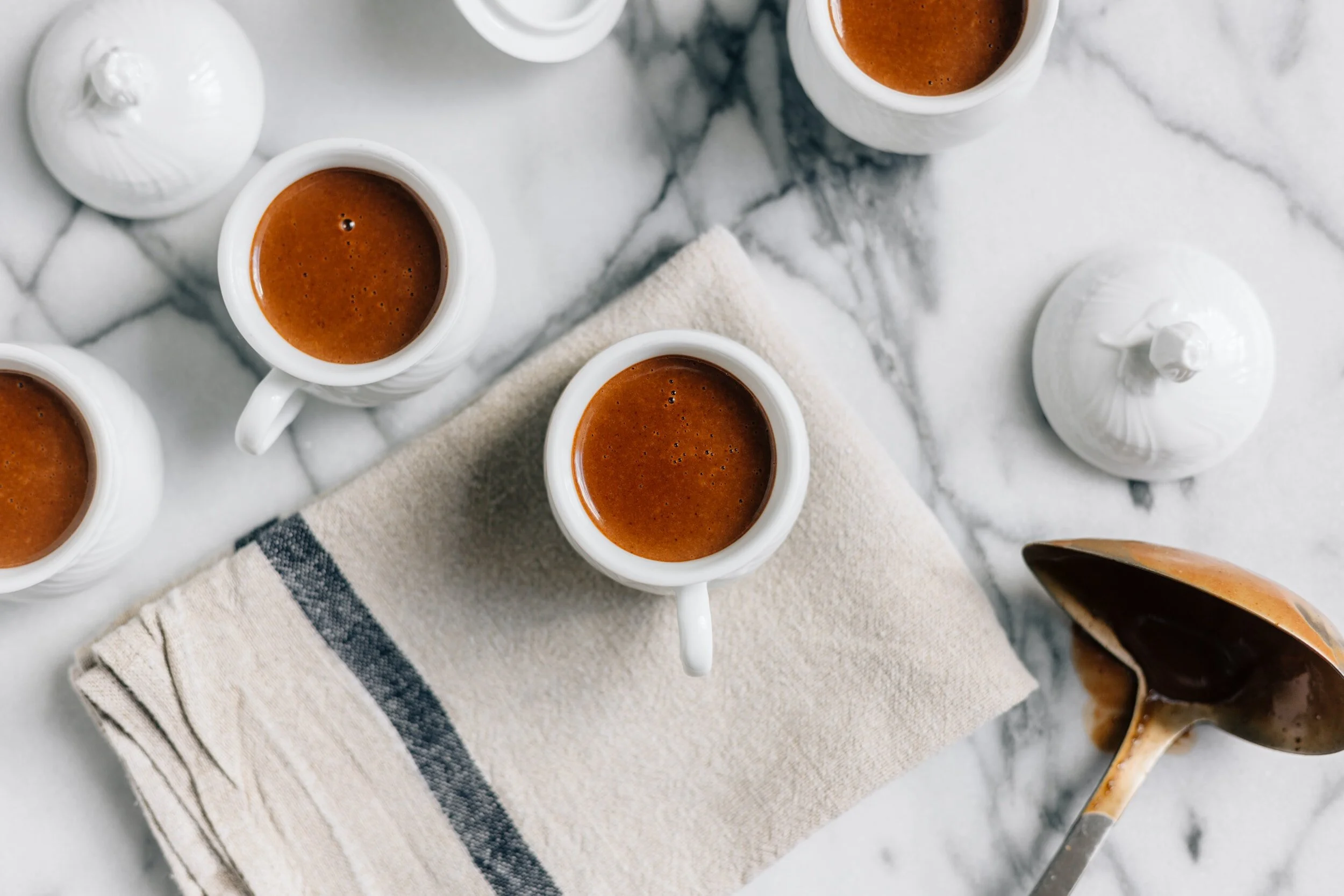 Cups of coffee sitting on a white Marble Countertop