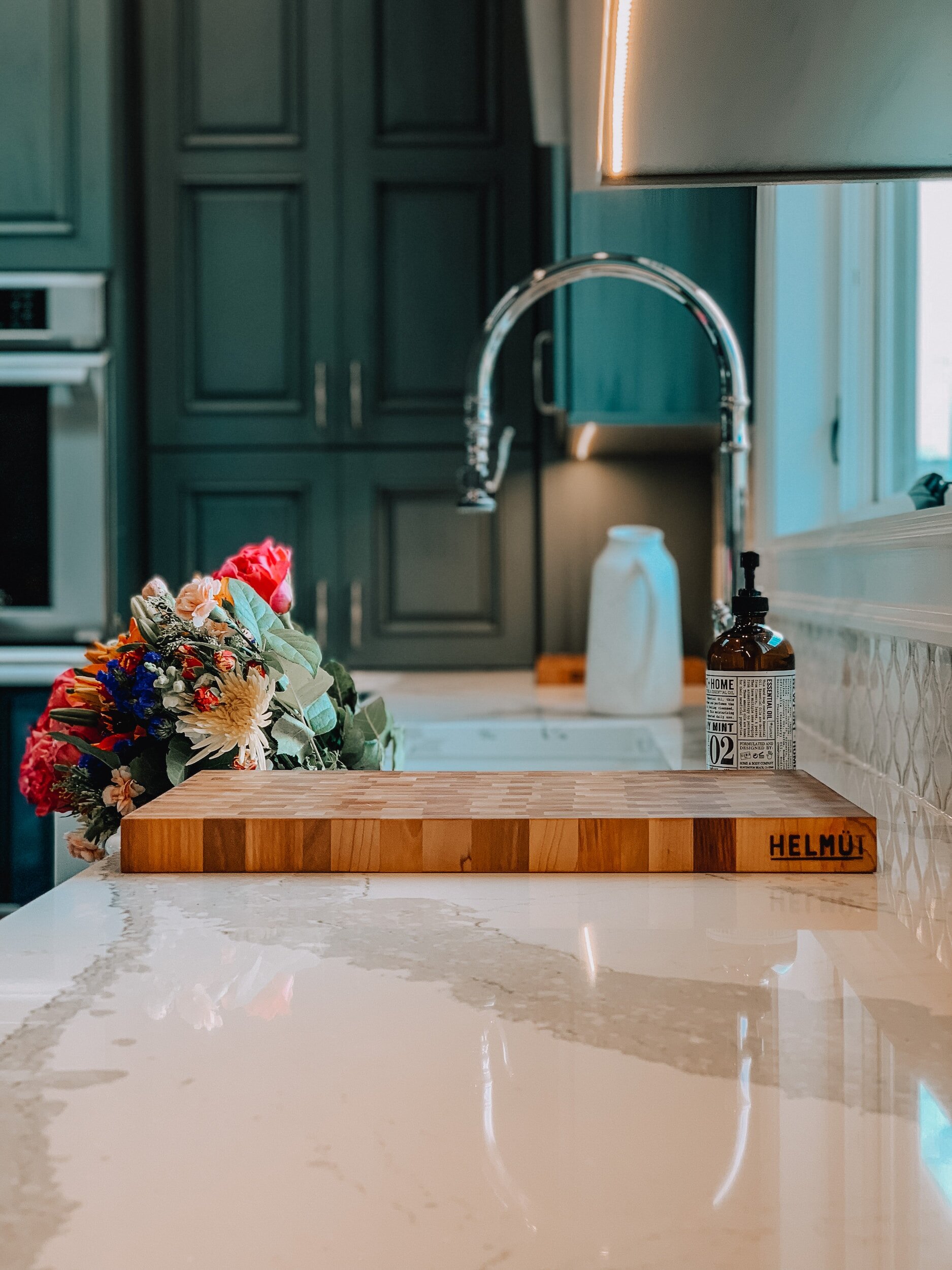 Kitchen with White Quartz countertops that have grey veining