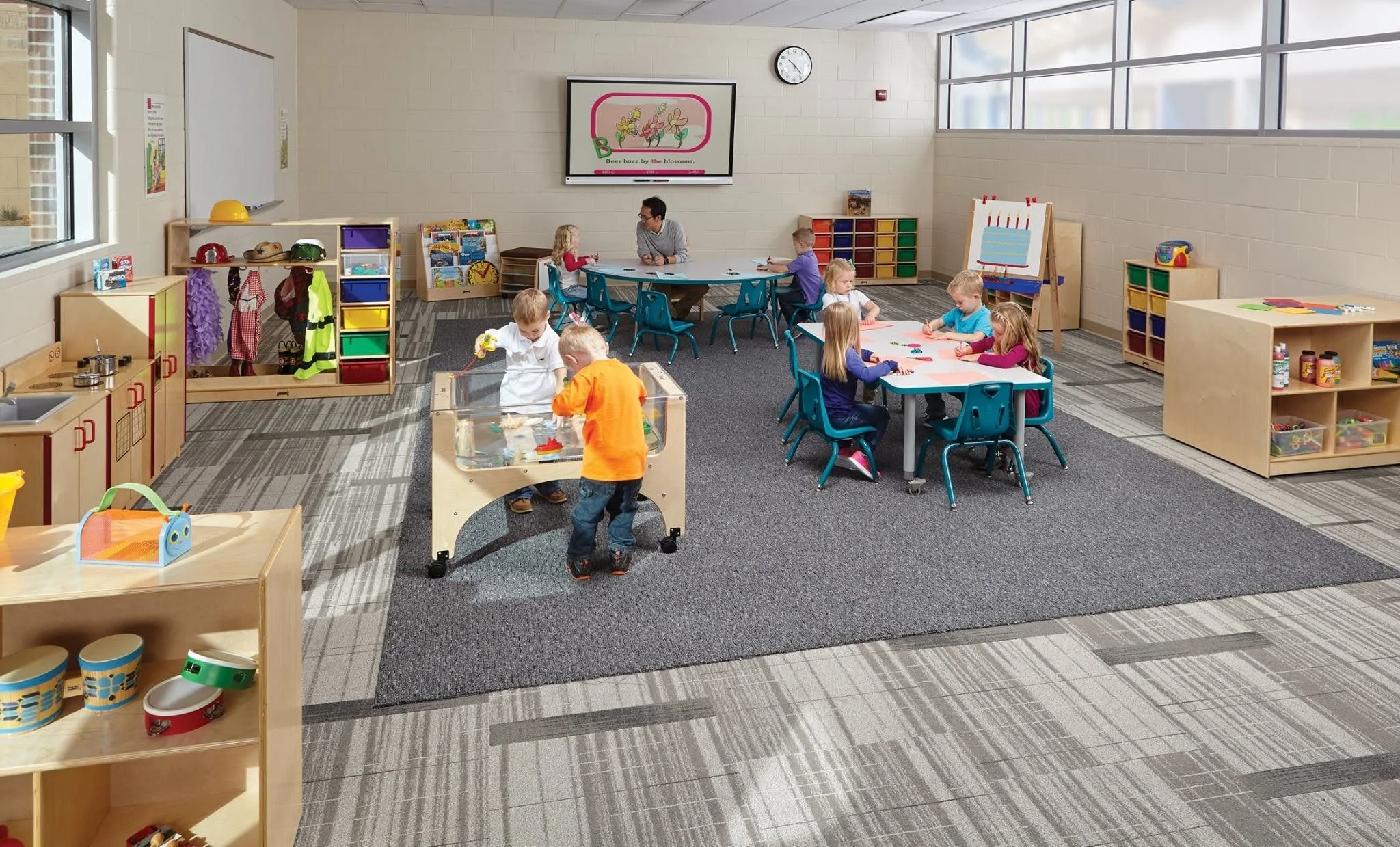 A dynamic secondary school classroom designed by Oxilium, equipped with various mobile furniture solutions including Alumni modular desks, National Public Seating ergonomic active stools, and nesting tables, integrated with high-end edtech and a neur