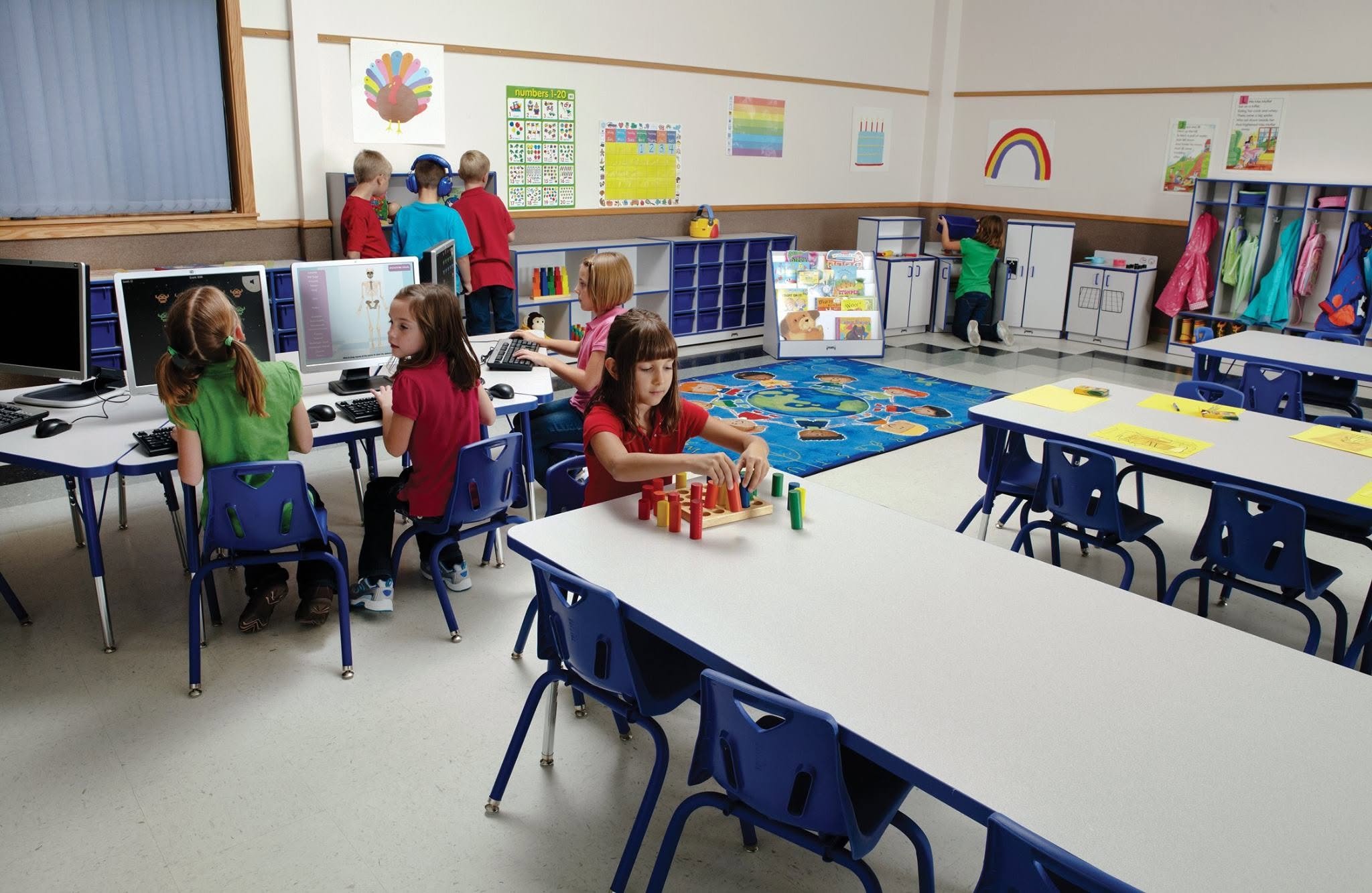 An inclusive K-12 SpEd support classroom designed by Oxilium, featuring flexible seating with active stools and bean bags, integrated learning edtech, a mobile acoustic reading pod, and a specialized neuro-inclusive tactile sensory zone.
