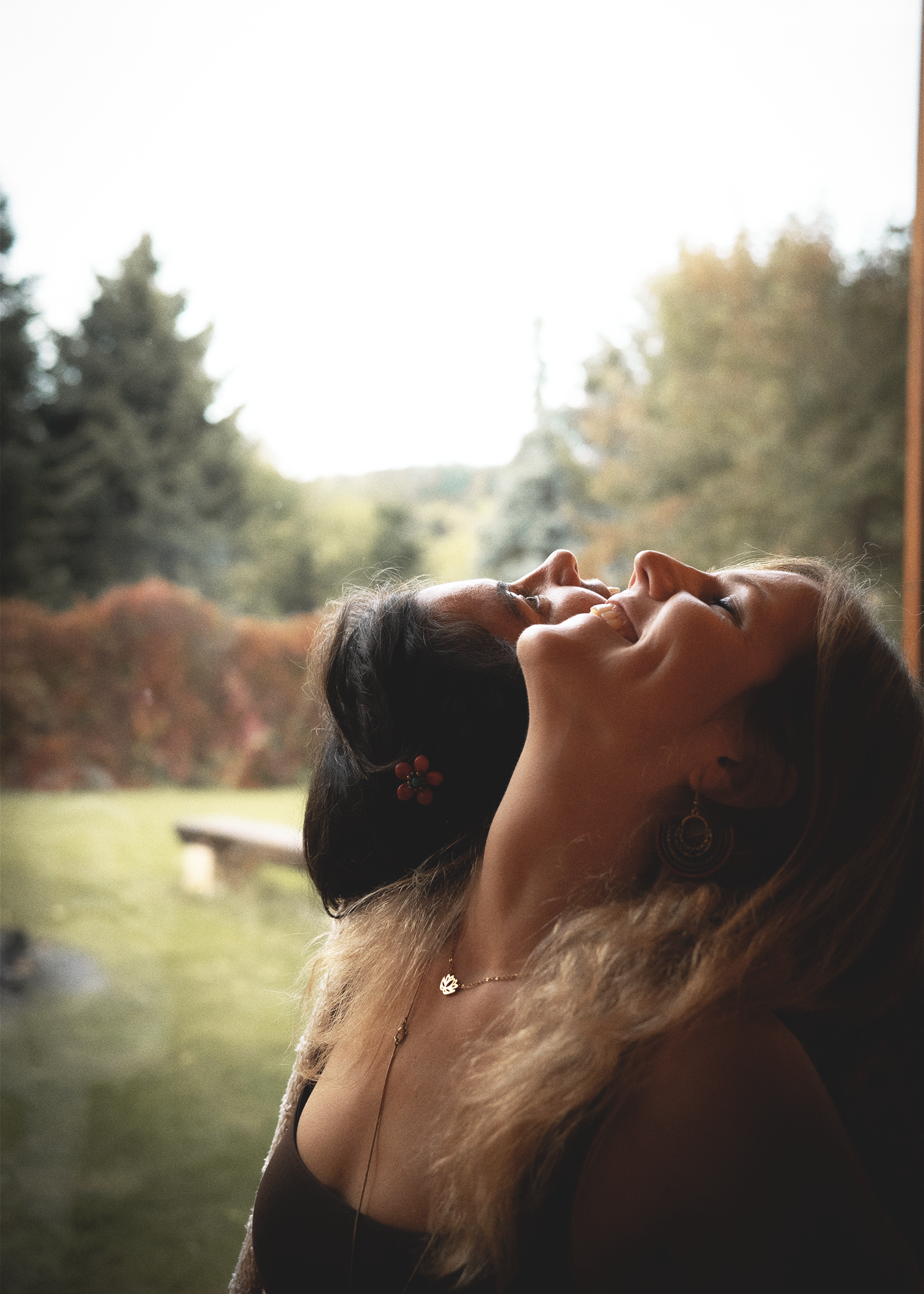 Two women resting together in nature.
