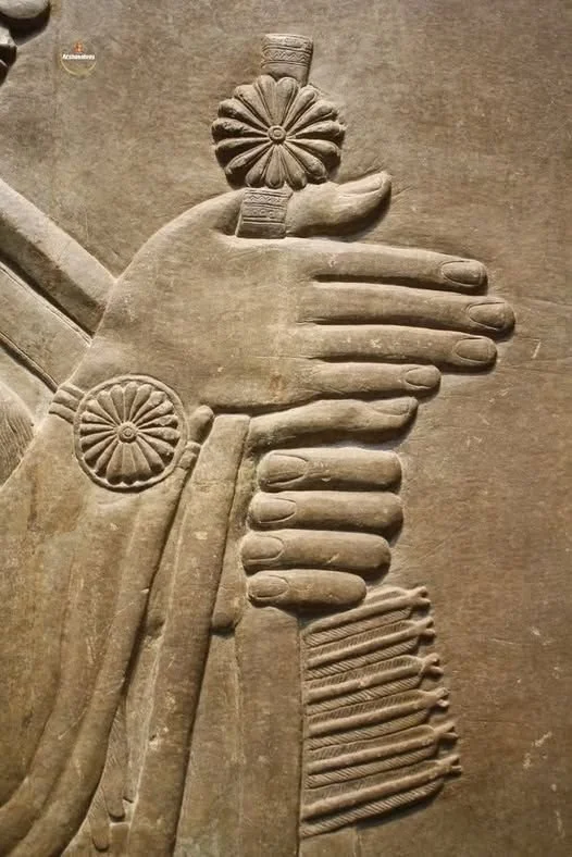 Stone sculpture of a human hand holding a lotus flower with intricate detailing.