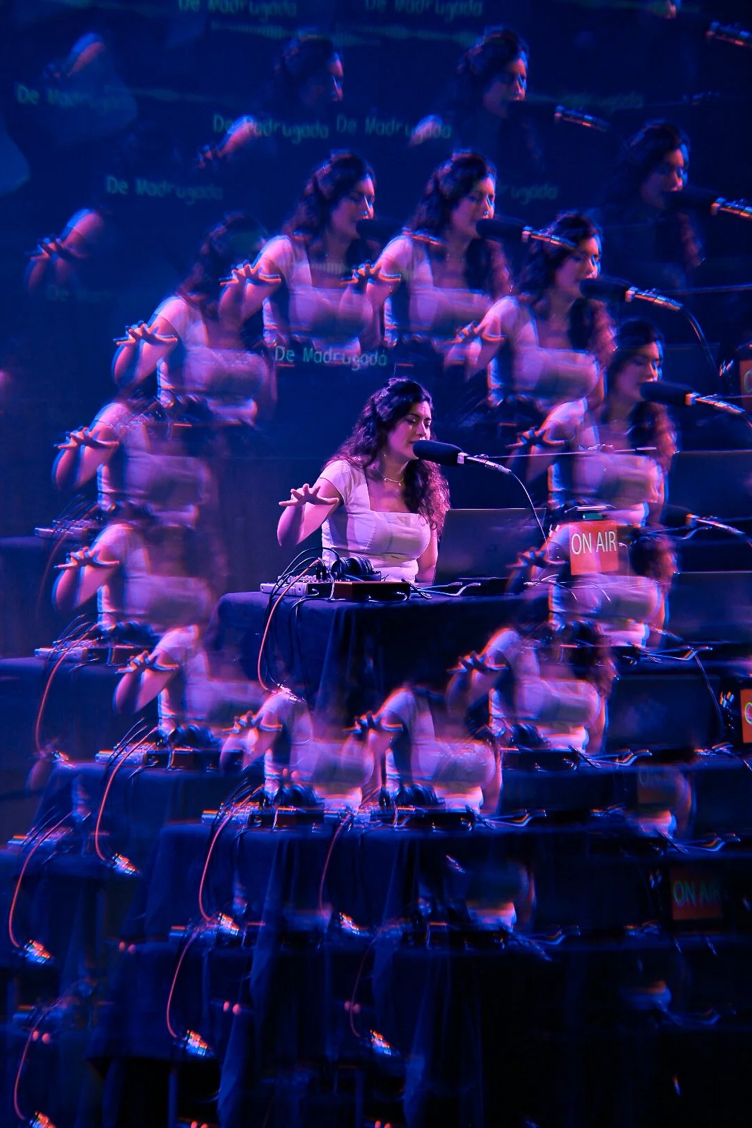 Laura in front of a microphone in a purple and black stage