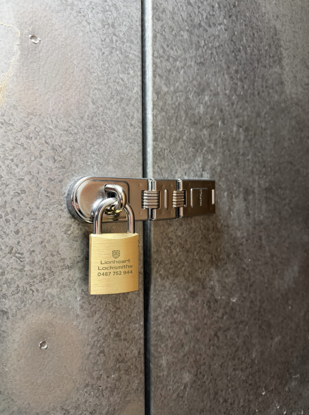 New padlock and hasp installation on a metal power box by Lionheart Locksmiths, providing secure locksmith services in Newcastle and Lake Macquarie.