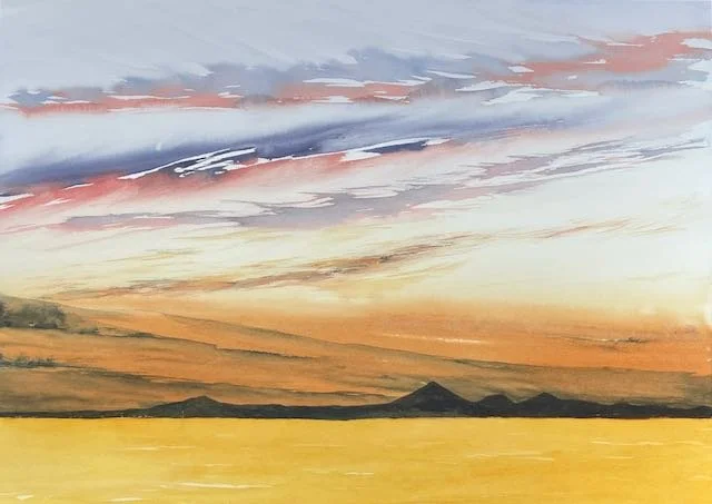 A watercolor painting of a sunset over a body of water with distant mountains and colorful sky.