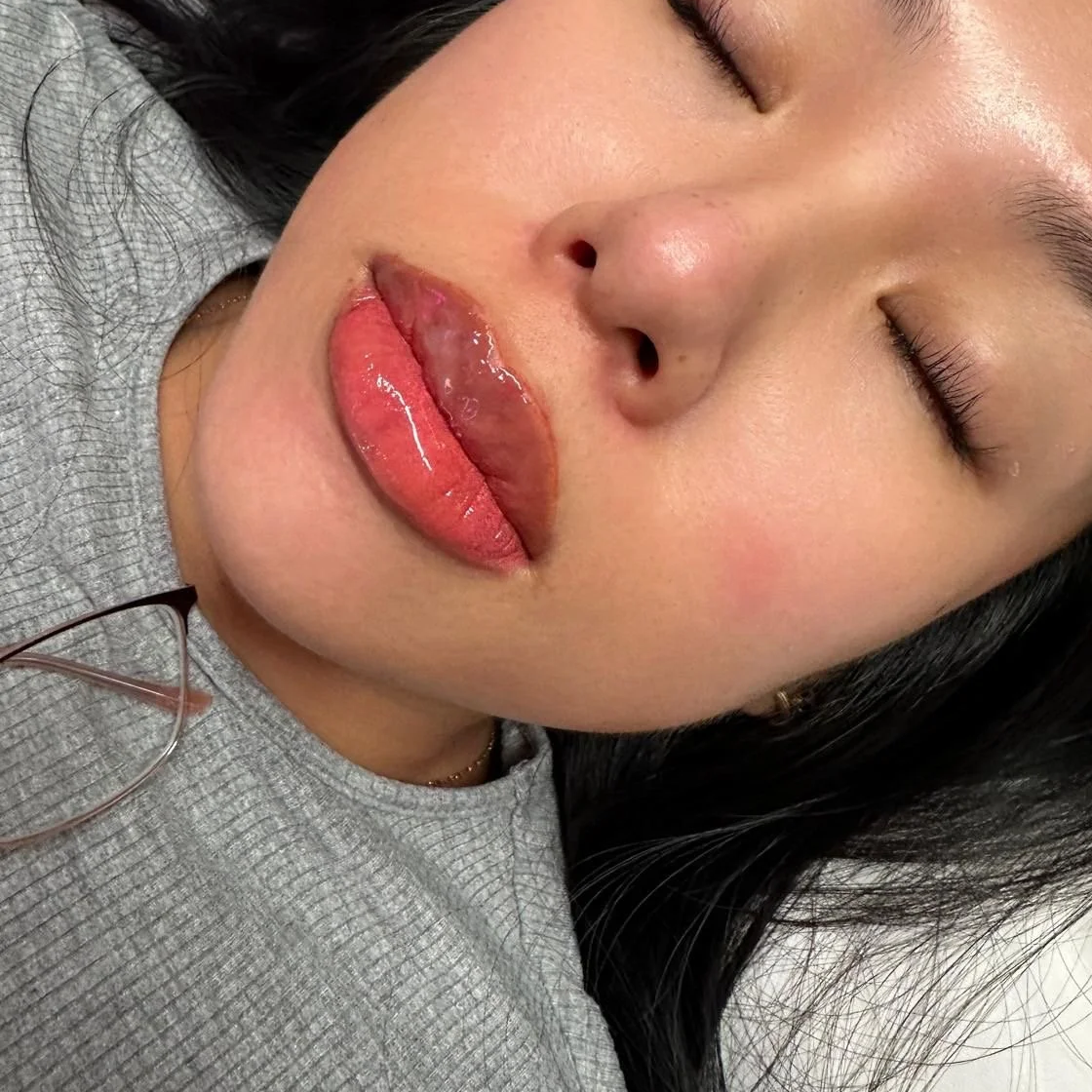 Close-up of a woman with her eyes closed, showing detailed facial features and glossy lips.