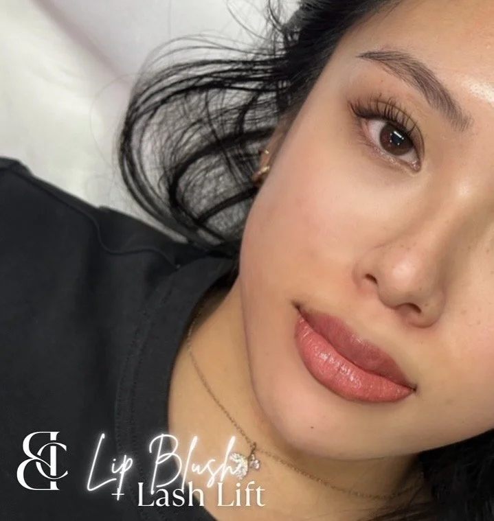 A woman with dark hair, light skin, and full lips, lying on a bed, with a neutral expression. Text on the image reads 'Lush Lip & Lash Lift'.