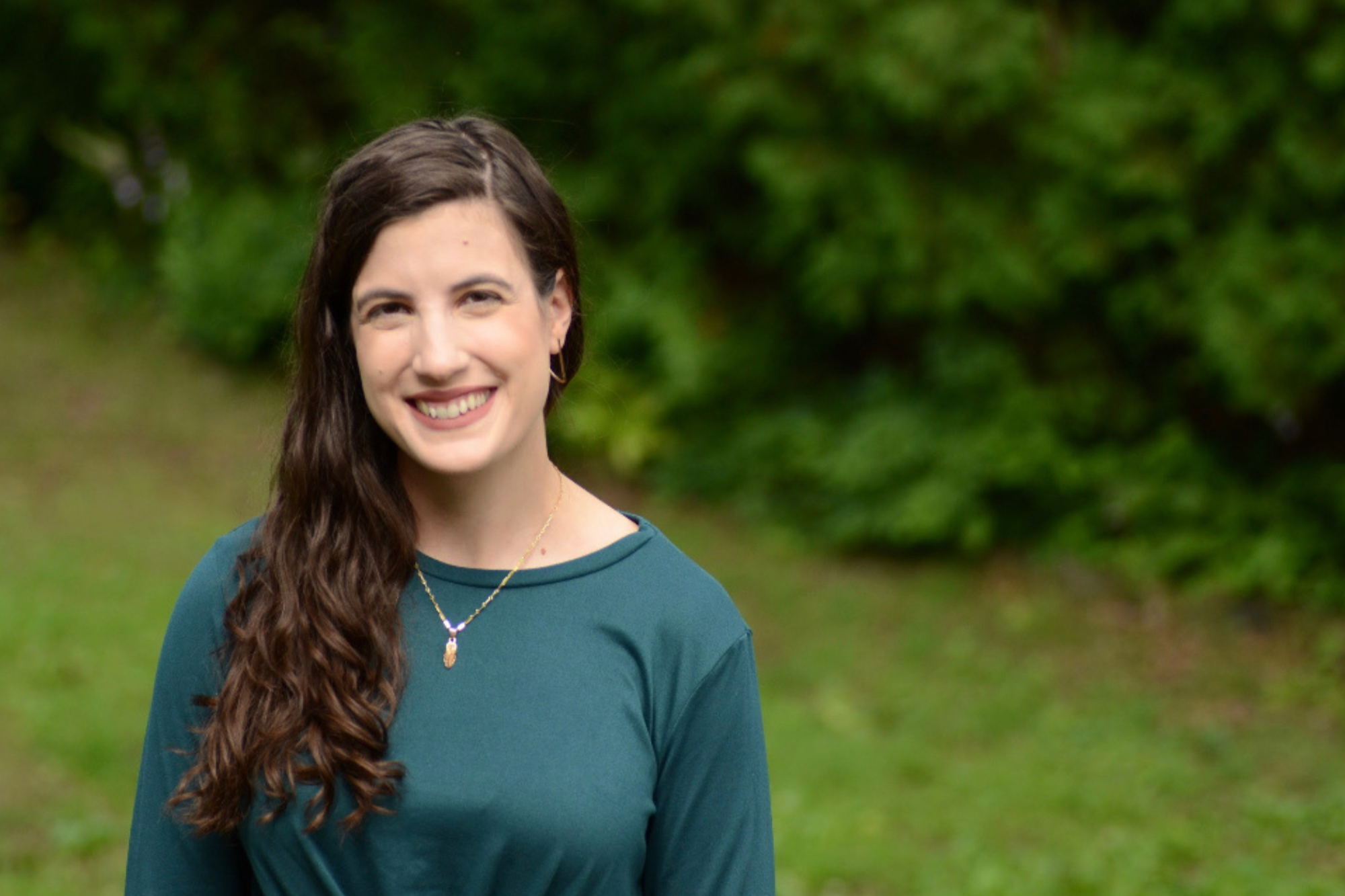 Therapist, Alice Zic, standing outside and smiling, representing supportive care offered through family trauma therapy in Falls Church, VA.