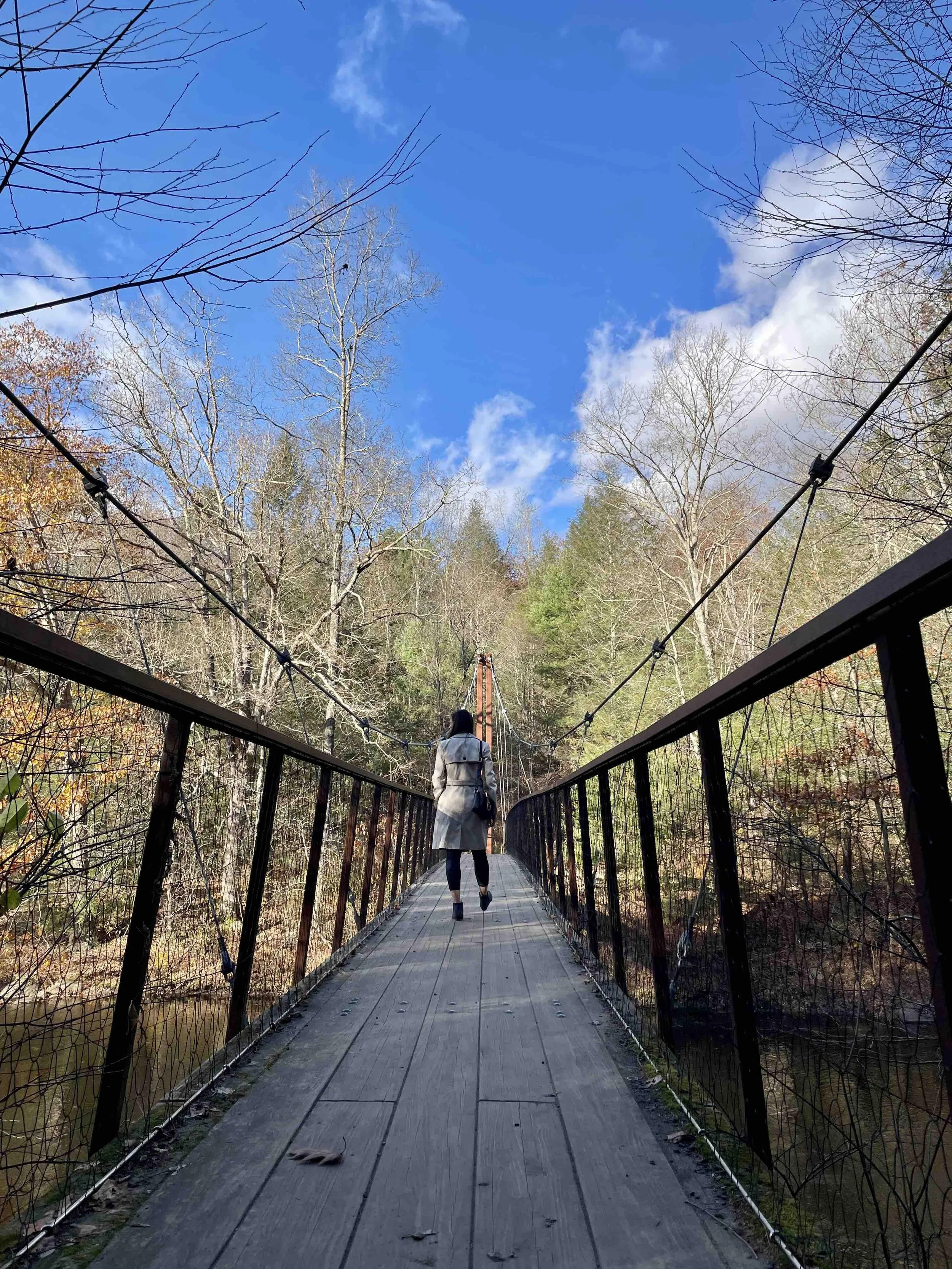 Photo of online therapist Alice Zic walking on bridge in Washington, CT to show online therapy in Connecticut and Virginia for childhood trauma and teen anxiety