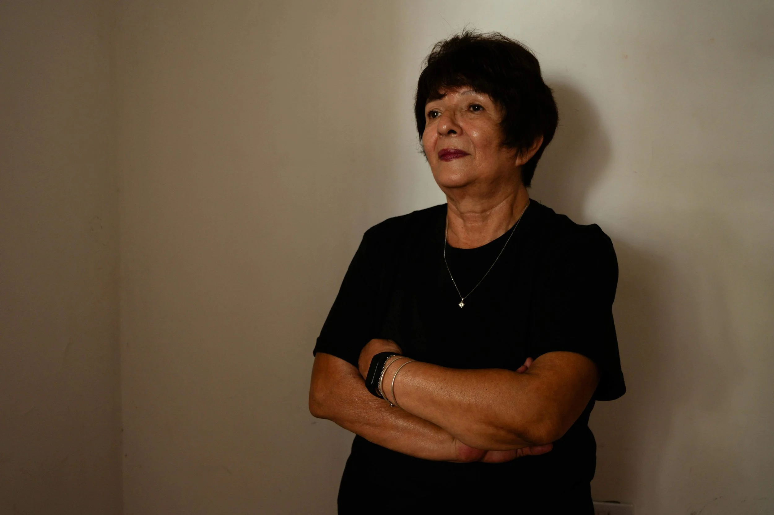 Woman with short hair and arms crossed, looking contemplative, illustrating identity exploration in culturally sensitive counseling in Falls Church, VA.