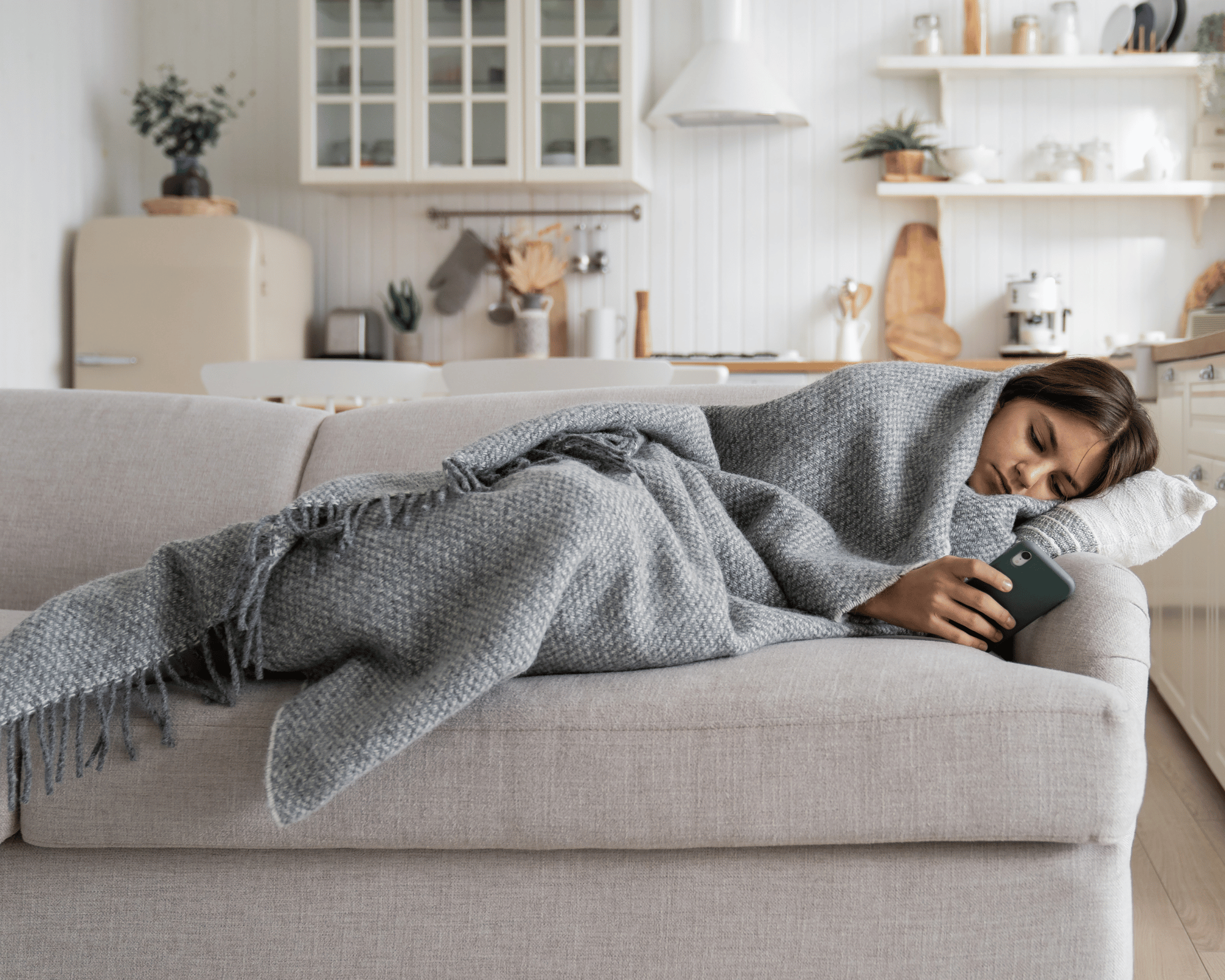 Image of isolated and overwhelmed teenager zoning out on a sofa to illustrate what is parentification trauma in Colchester, Connecticut 06415 and Virginia
