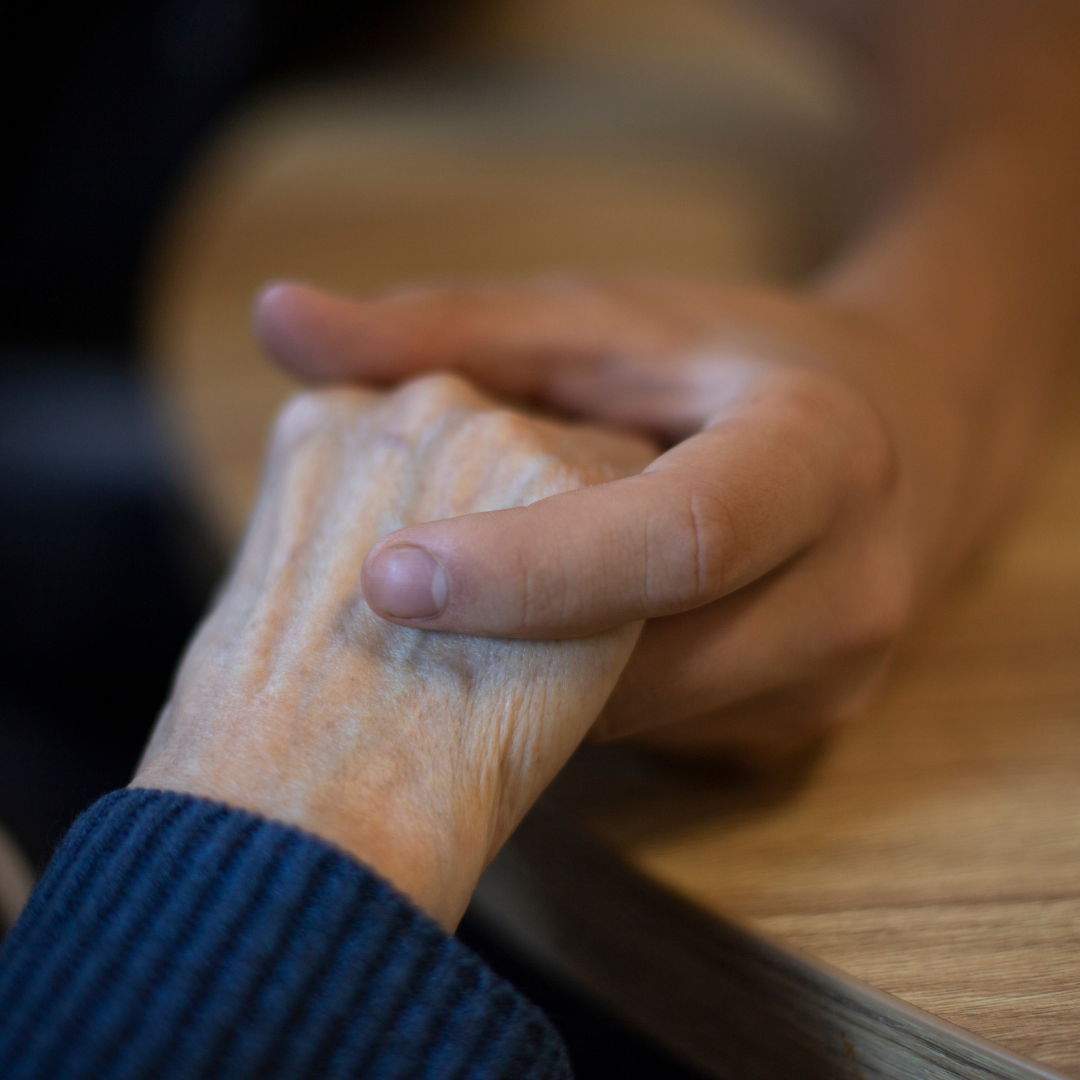 Image of two individuals holding hands to illustrate impact of intergenerational trauma & parentification trauma therapy in Colchester, CT 06415 & Virginia