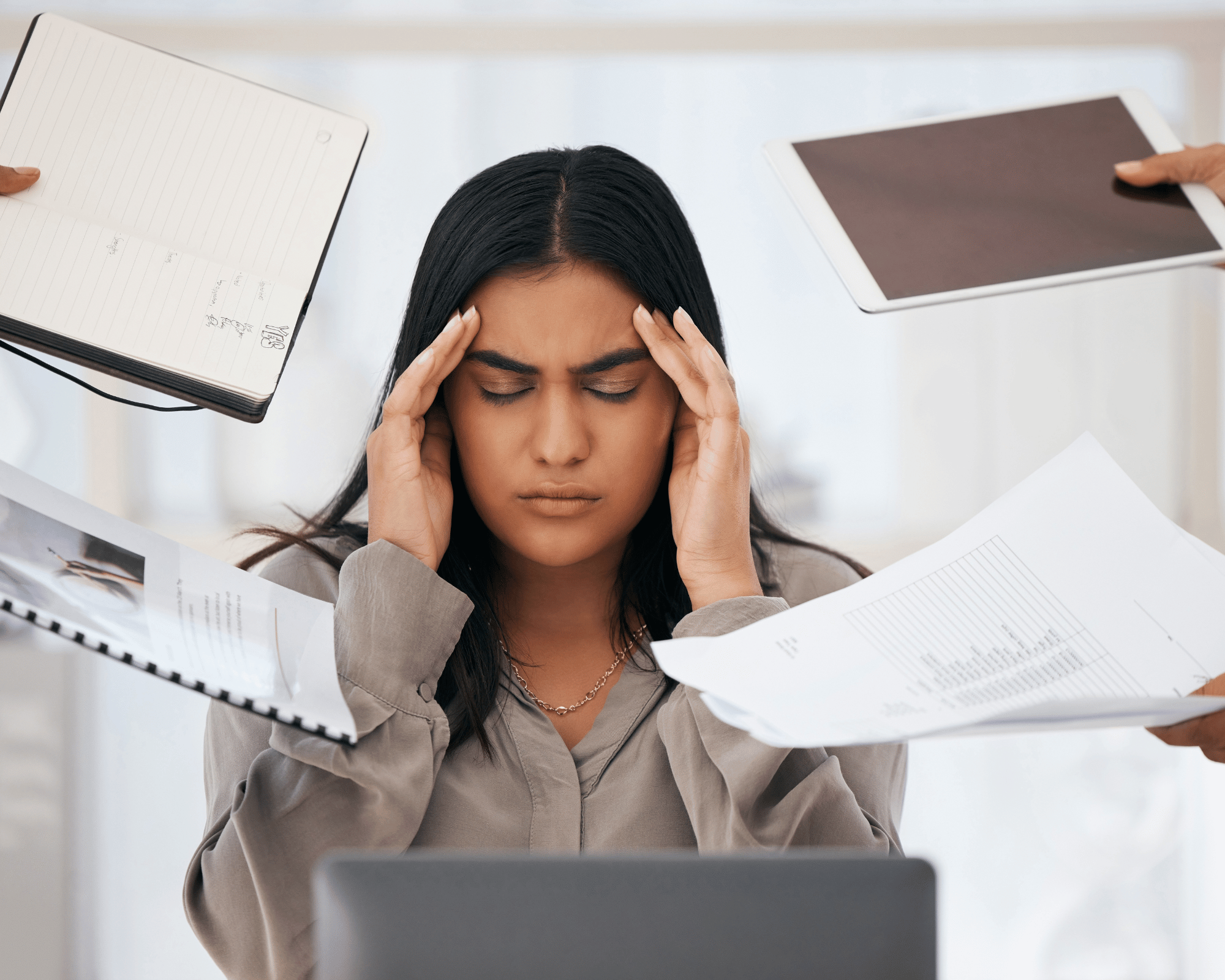 Image of stressed and overworked first generation woman to illustrate parentification trauma therapy in New Orleans, LA, Colchester, Connecticut & Falls Church, Virginia