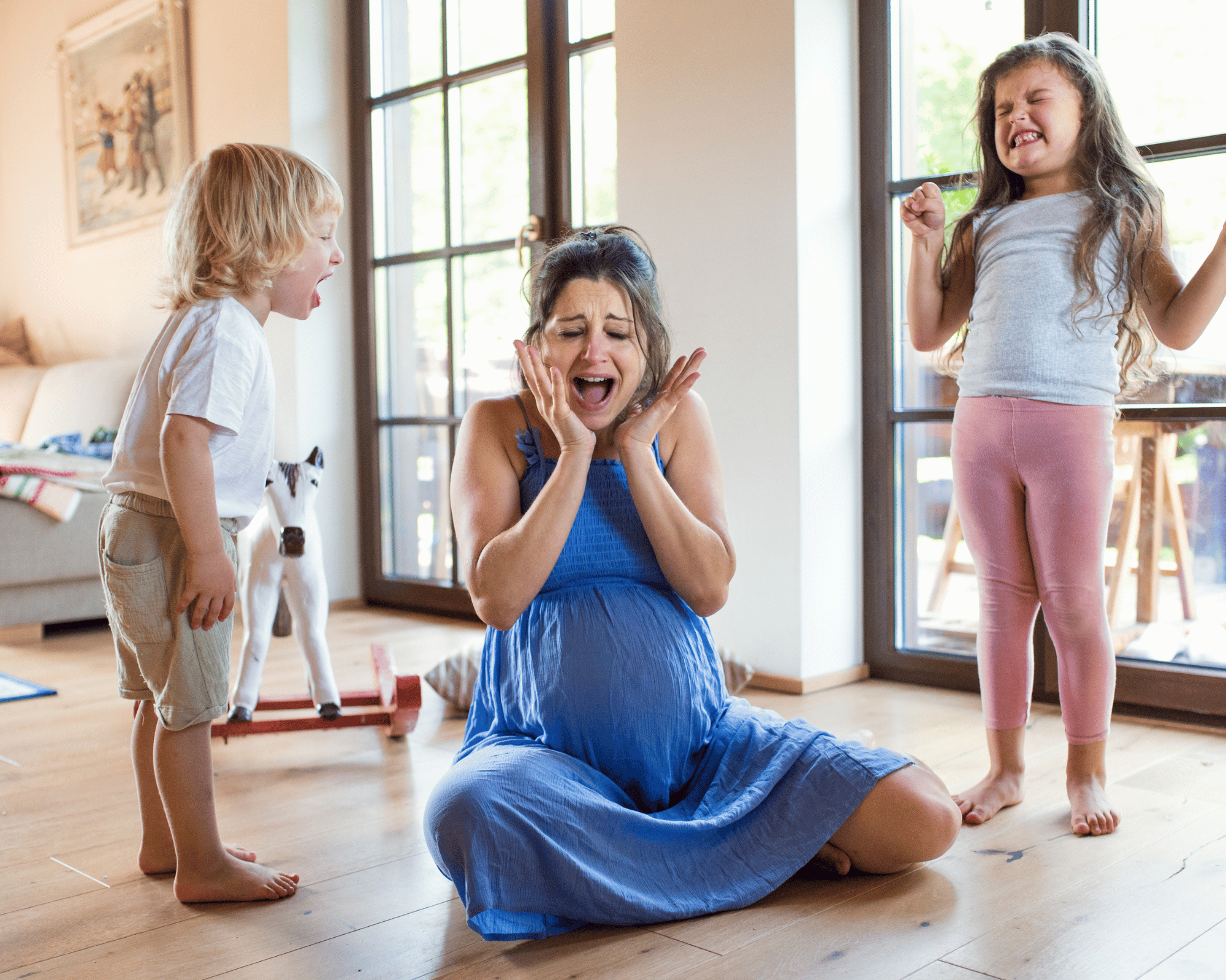 Image of overwhelmed mother surrounded by screaming son and daughter to illustrate what is parentification trauma in Colchester, Connecticut and Virginia