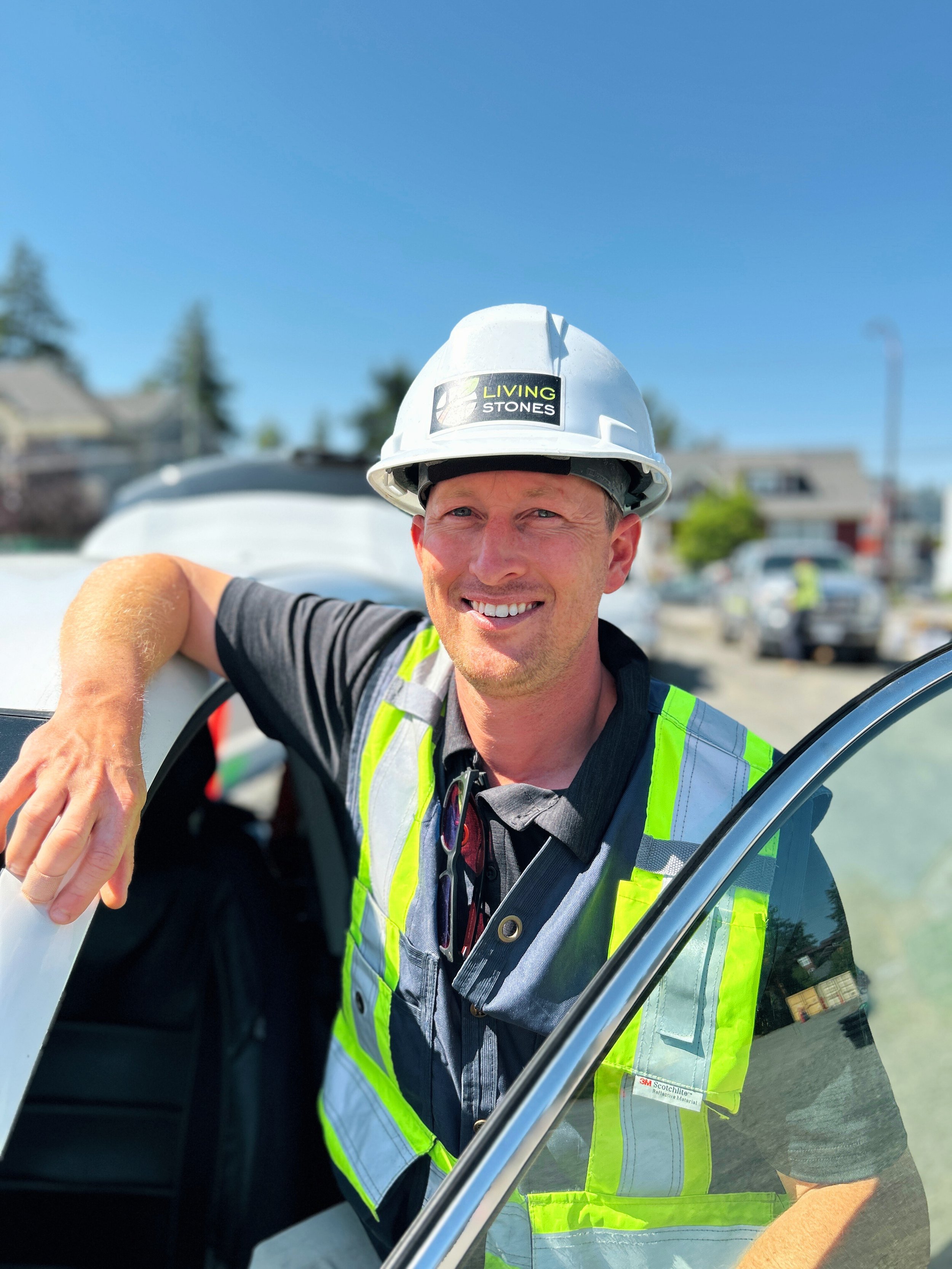 A man wearing a white safety helmet with a 