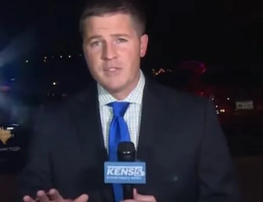 James Keith when he was a reporter at KENS 5 holding a microphone with the logo 'KENS 5', standing outdoors at night with city lights in the background.