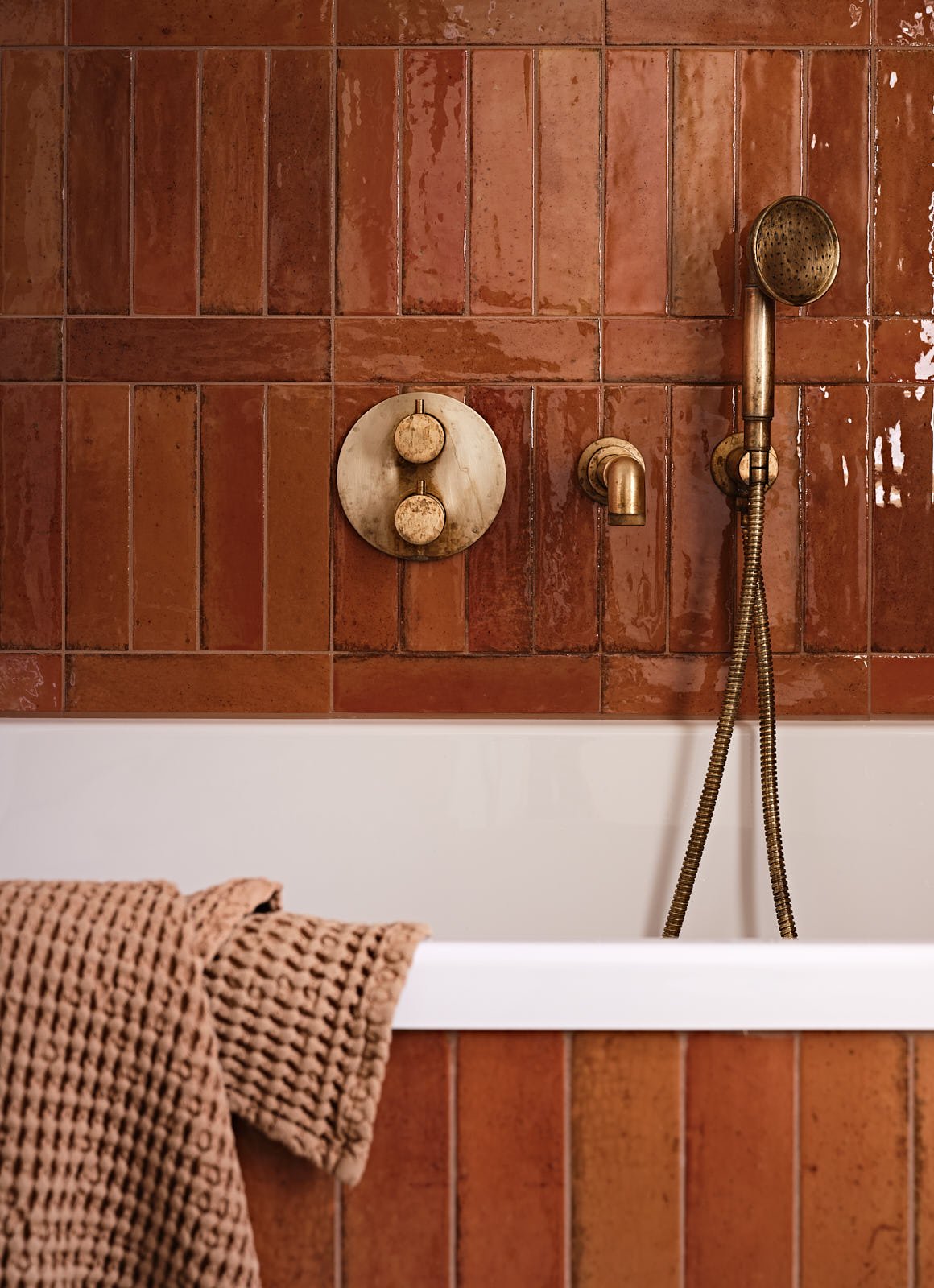 Brass bath fittings in a family bathroom in East London, designed by Studio Eight Design.