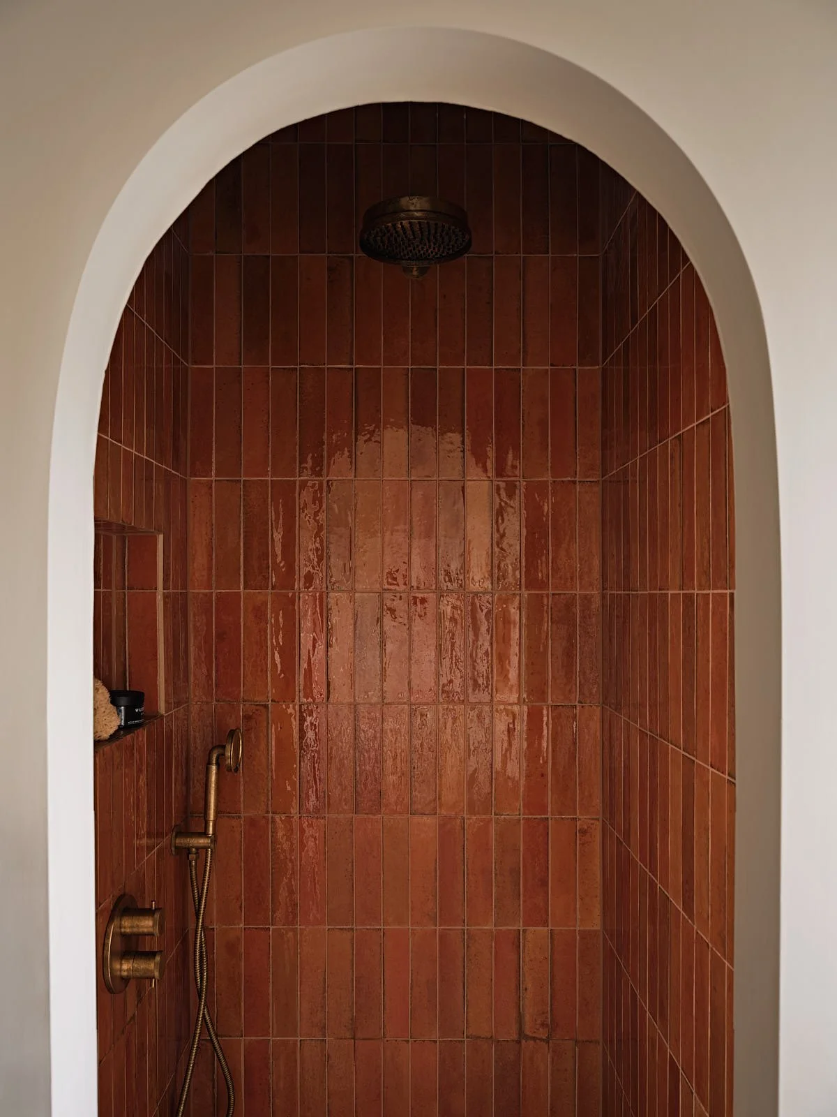 Arched shower in a London family bathroom, designed by Studio Eight Design.