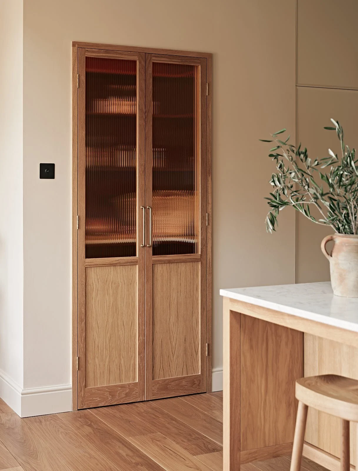 Oak pantry doors in a kitchen renovation in Aldersbrook, London designed by Studio Eight Design.