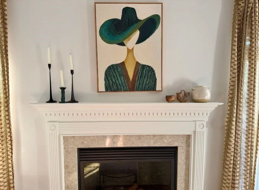 fireplace with portrait of woman with green jacket and green hat