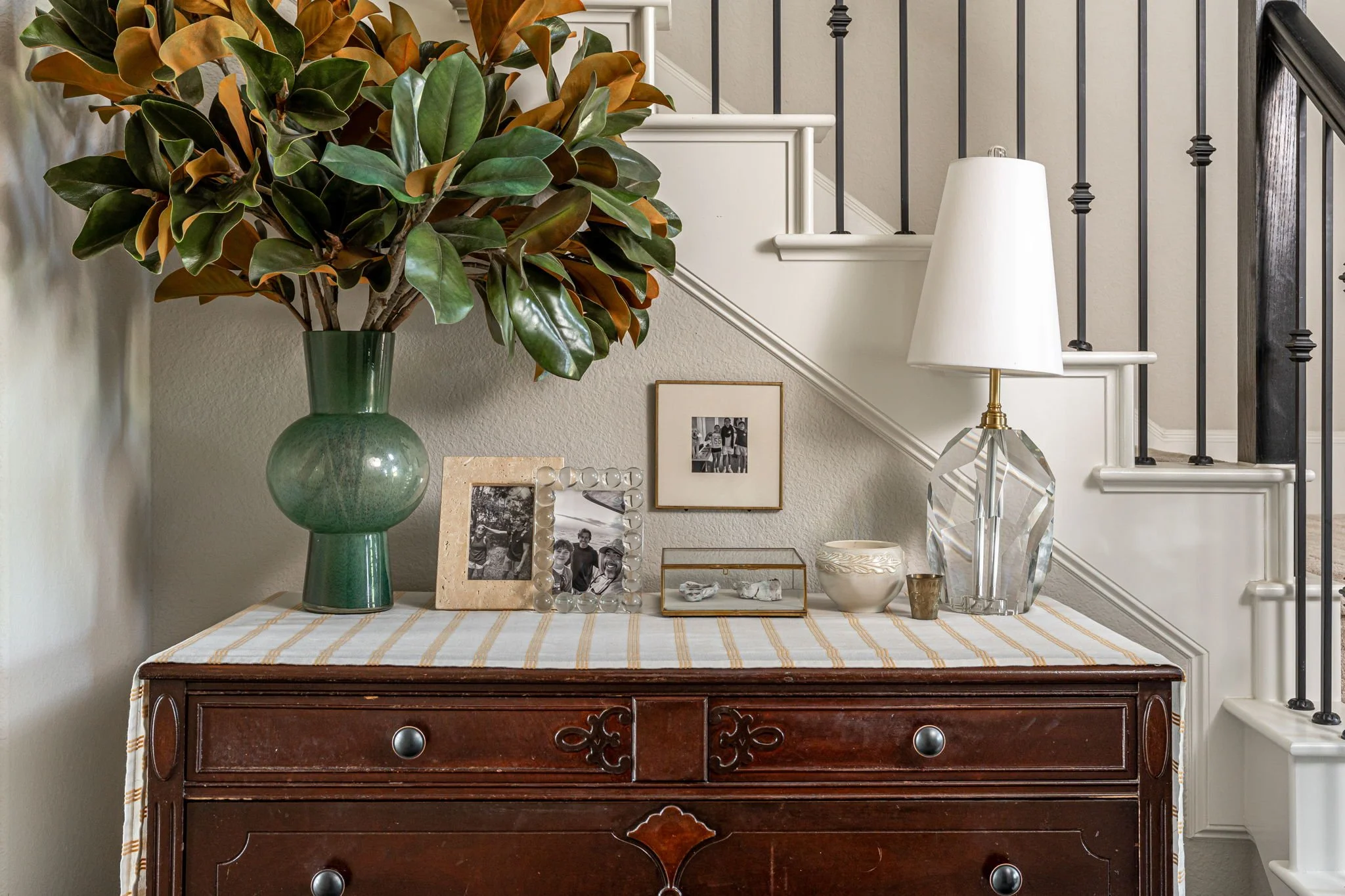 Dresser styled in entryway. 