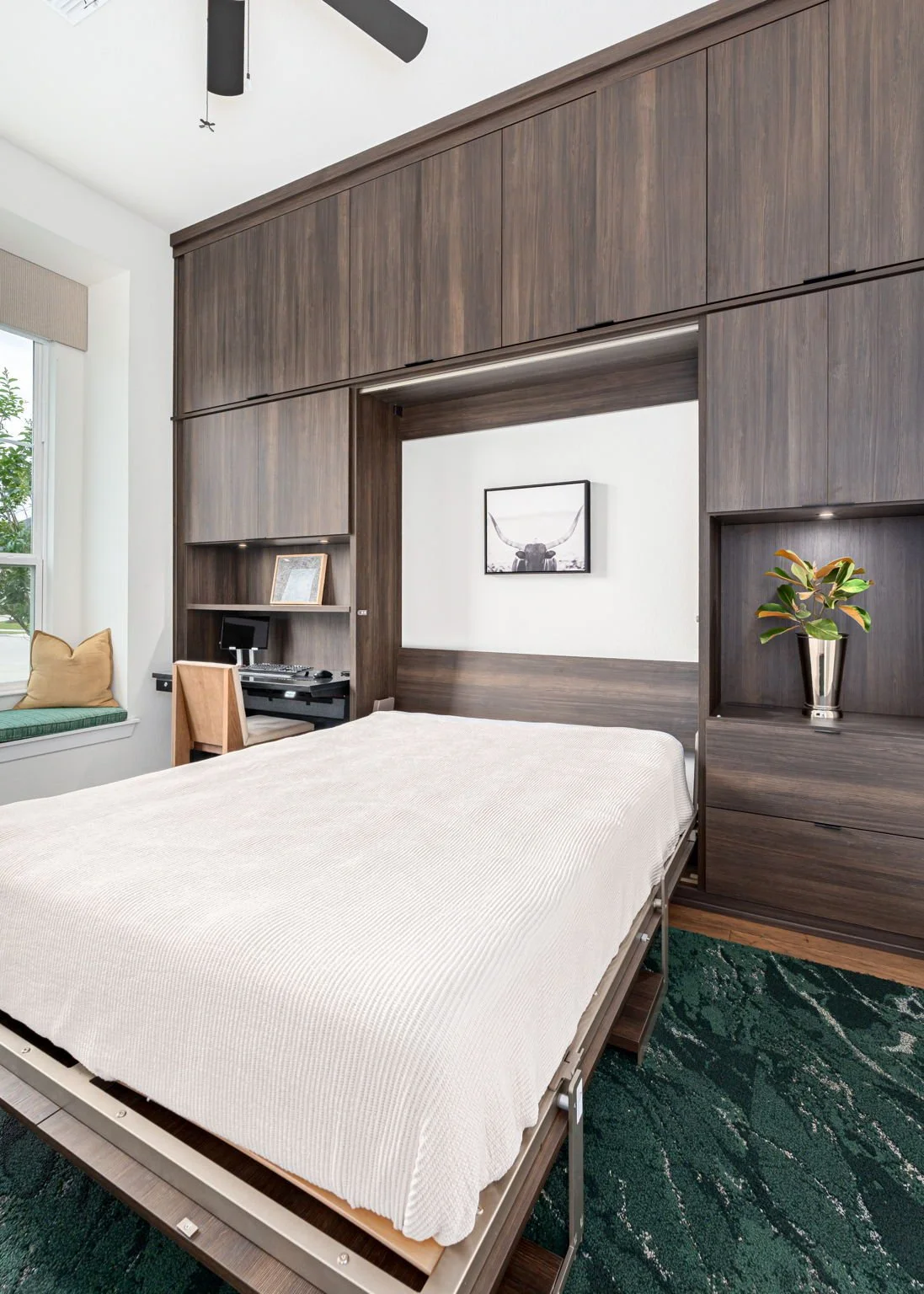 Office with wall bed in dark wood cabinetry