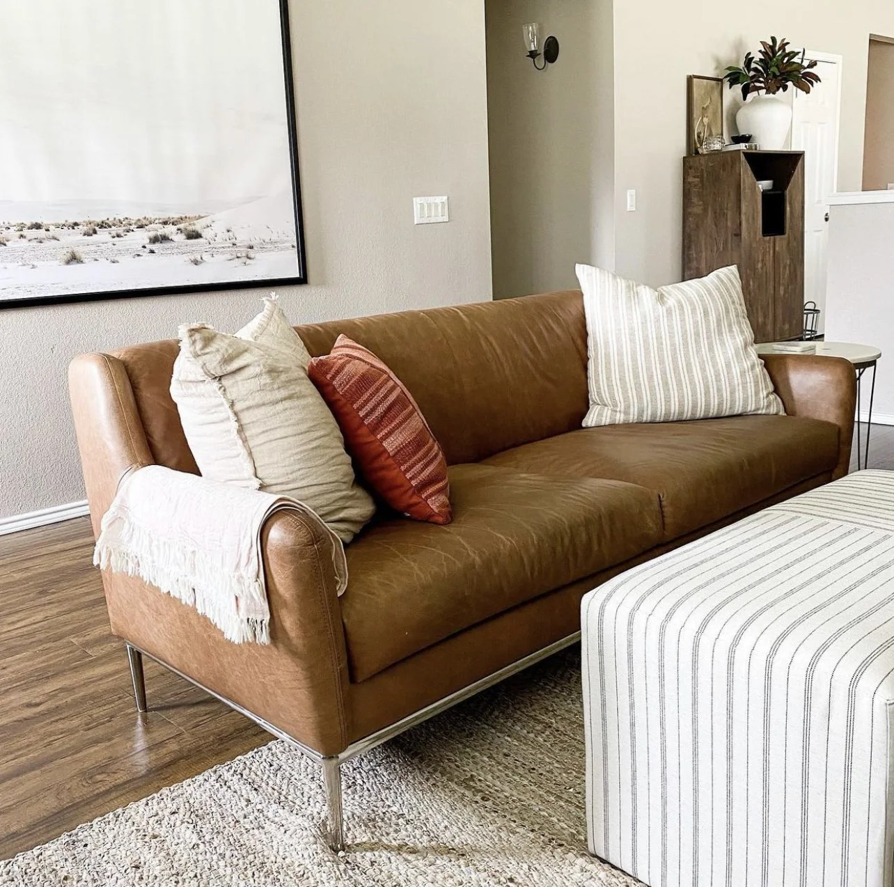 leather sofa with striped ottoman.PNG