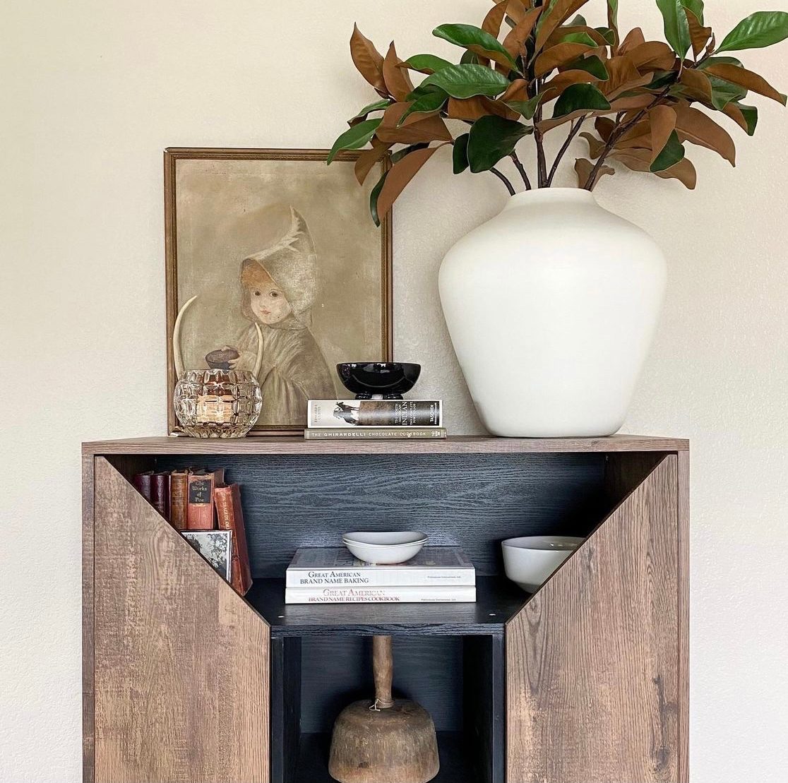wood cabinet styled with magnolia branches.PNG