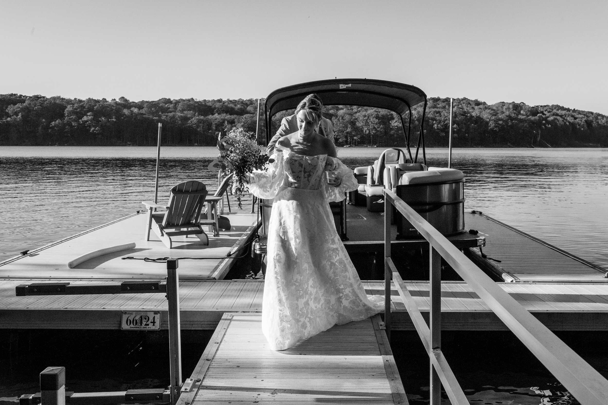 Photo of Bride walking off a boat onto a dock; from a private estate wedding in Deep Creek, VA. By Rey Lopez Photo