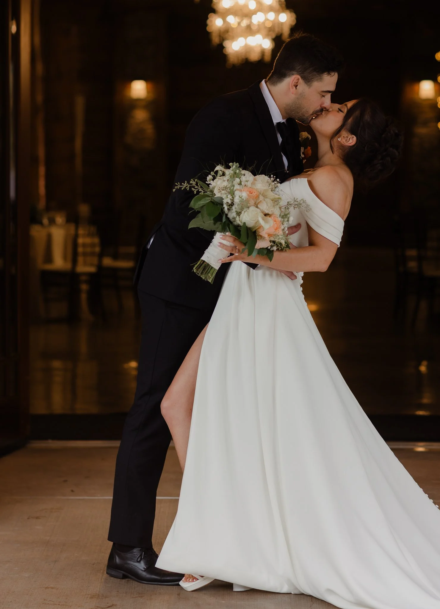 bride dip by groom while they kiss after wedding ceremony holding bridal bouquet at seven springs in pittsburgh