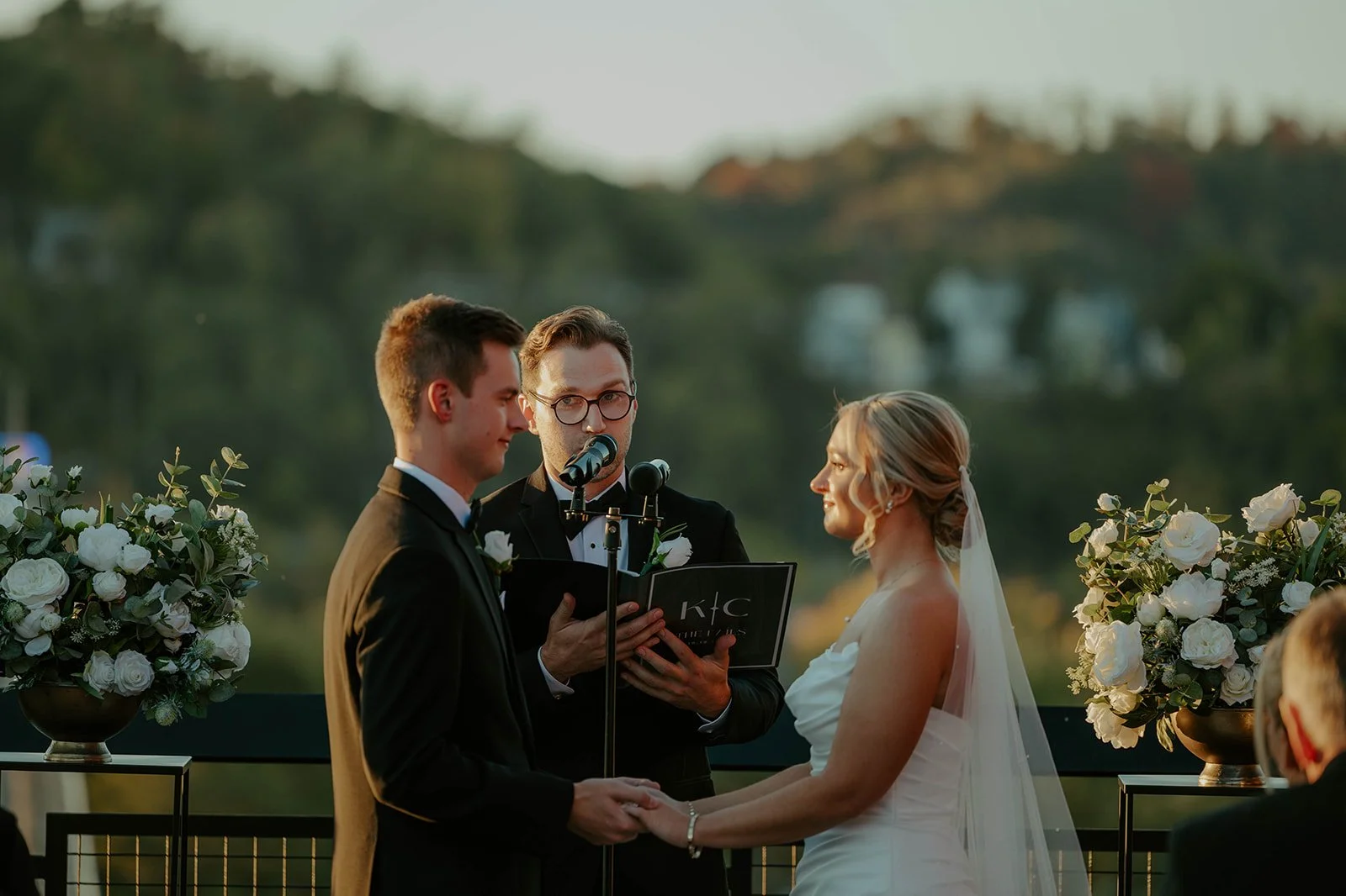Gorgeous shot of emotional bride and groom during their ceremony on thee rooftop of one of Lawrenceville's favorite venues, Over Eden.