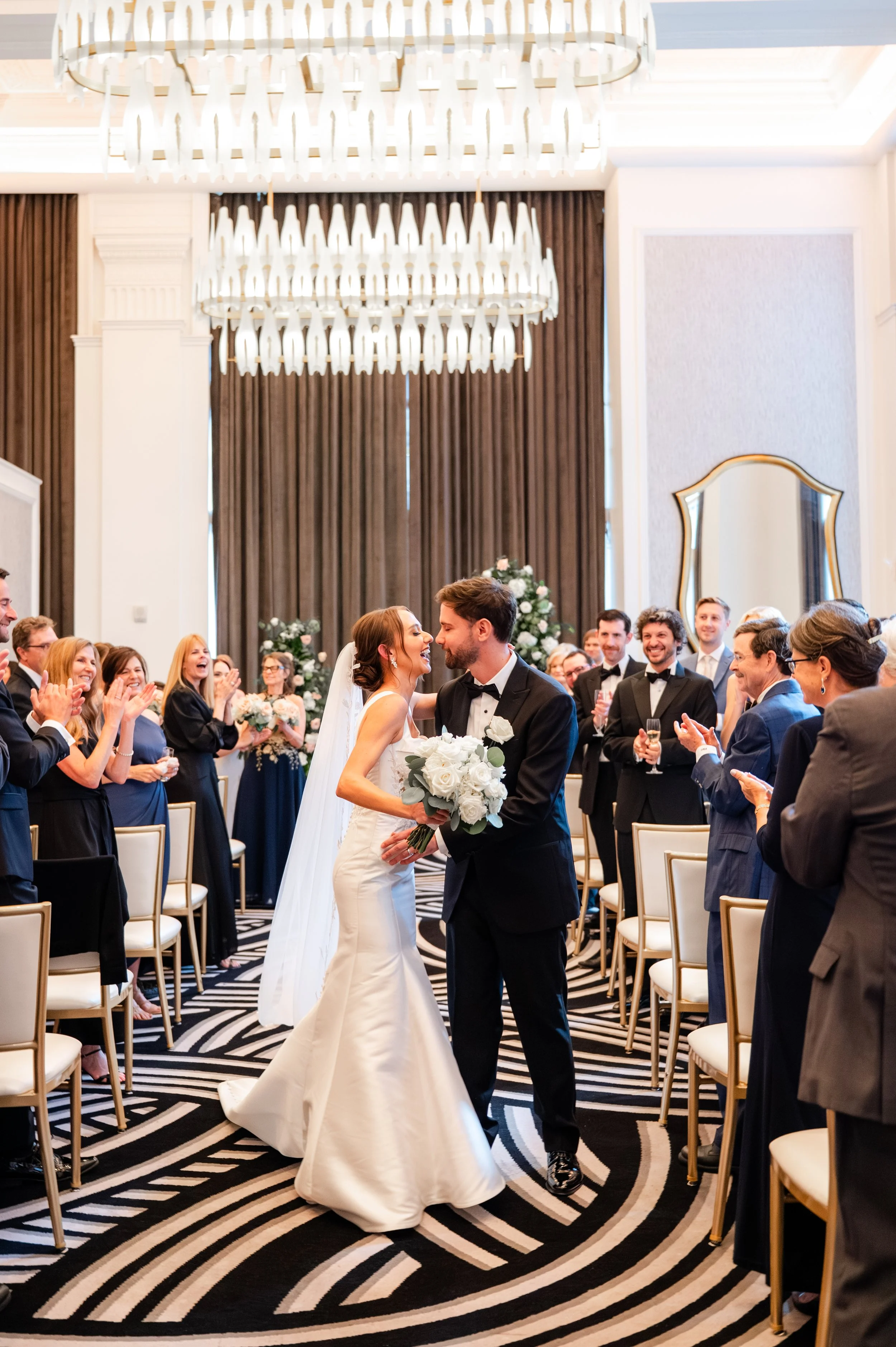 Bride and groom about to kiss, in the middle of their Hotel Monaco aisle.