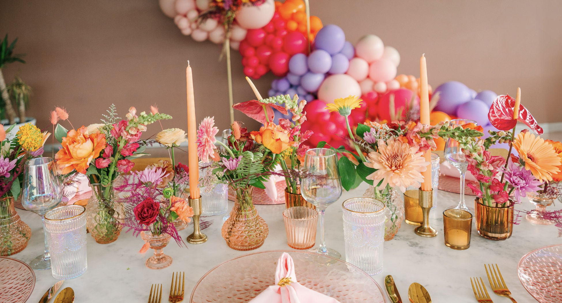 Detailed tablescape shot from the unique and colorful styled shoot for Lush Event Co. featuring vintage glassware, balloons, and bold florals.