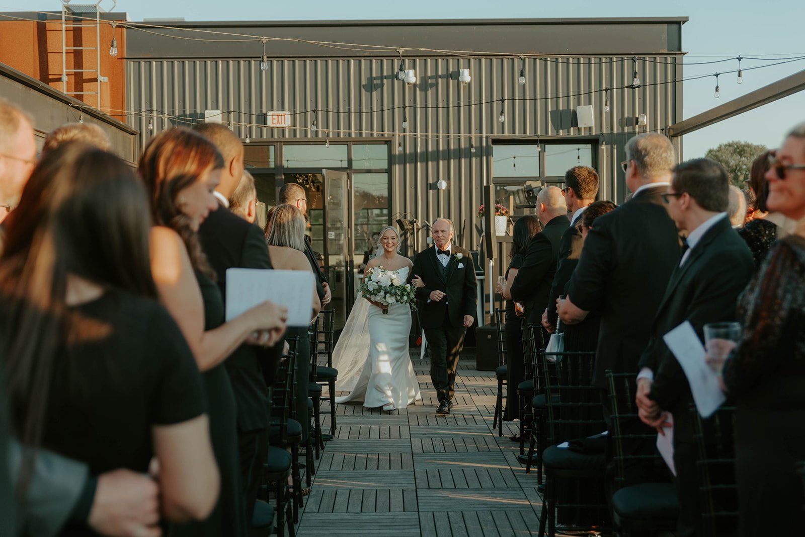 Bride walking down the outdoor aisle on the rooftop at Over Eden in Pittsburgh.