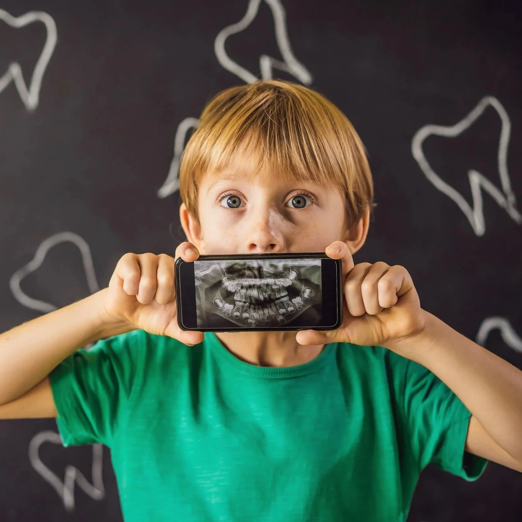 Young boy showing his digital dental x-rays