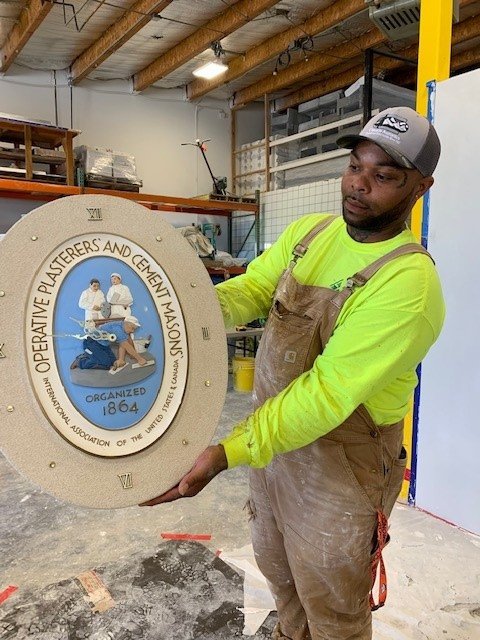 Apprentice Joshua Jenkins with cast and painted piece. Photo by Lainie Ettinger.