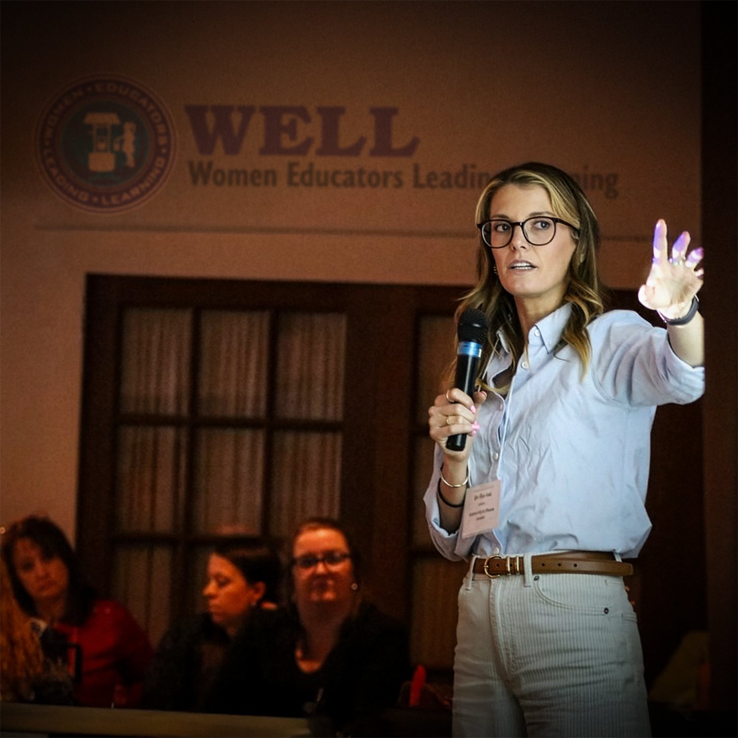 Professional women teaching a group.