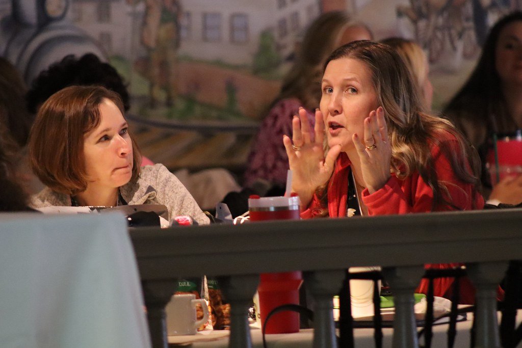 Professional women smiling and exchanging ideas at a conference