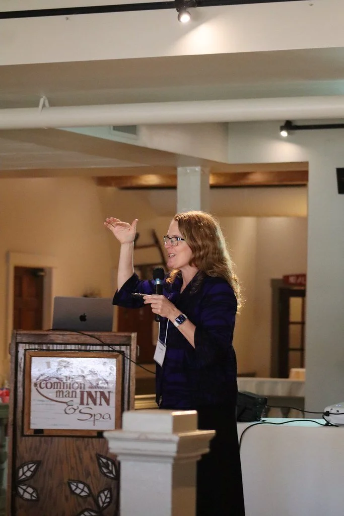Woman speaking at a WELL Women Educators Leading Learning educational conference