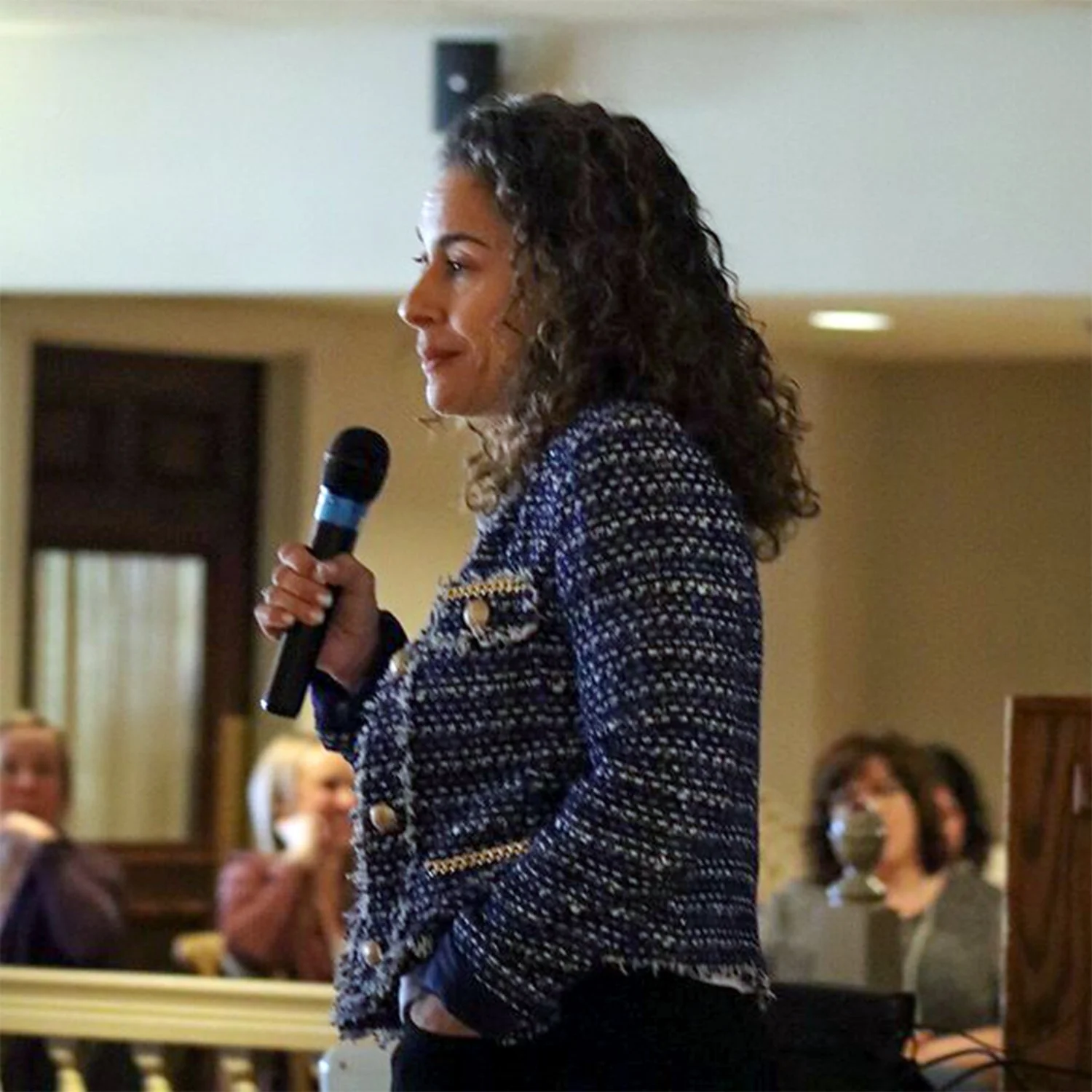 Woman speaking at a WELL Women Educators Leading Learning educational conference