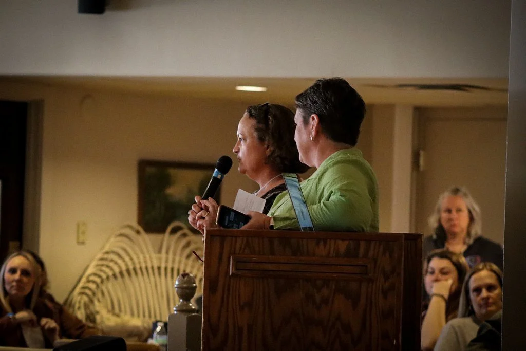 Women speaking at a WELL Women Educators Leading Learning educational conference