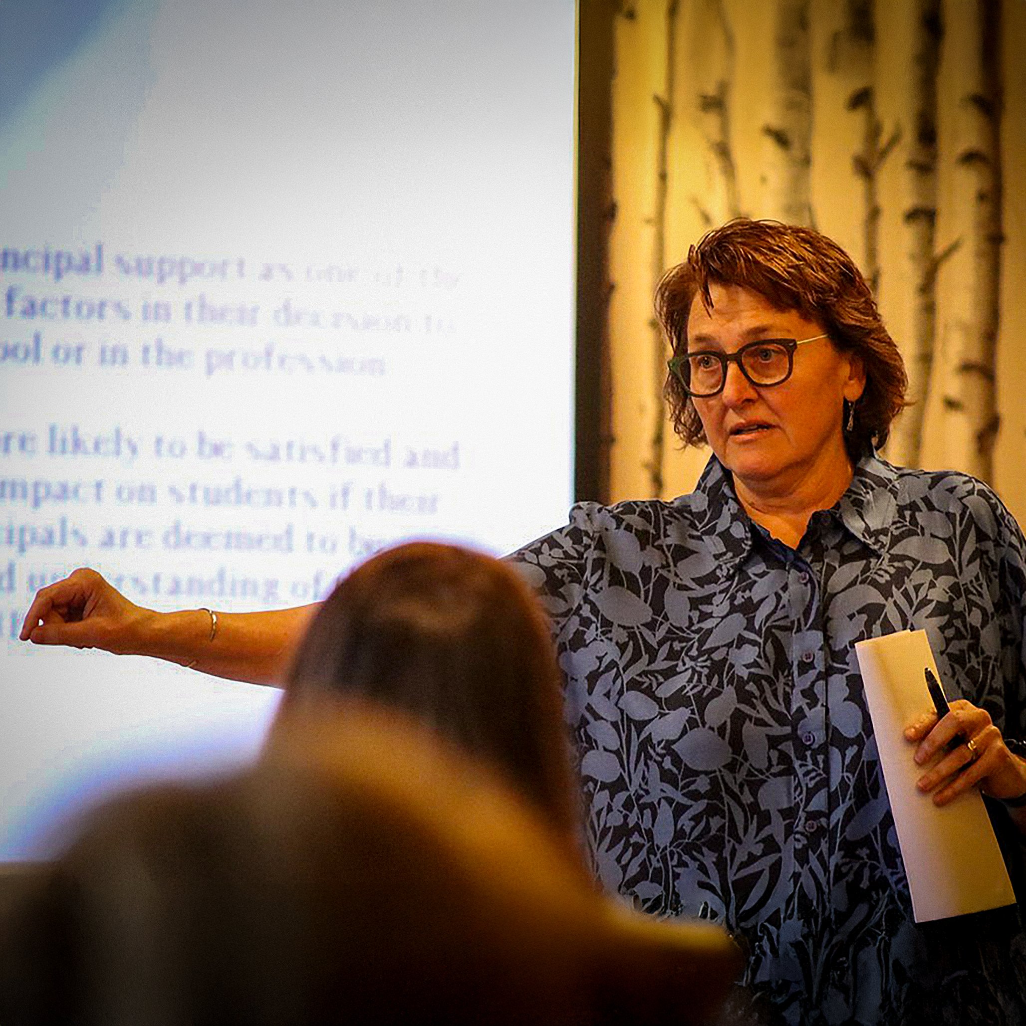 Woman speaking at a WELL Women Educators Leading Learning educational conference