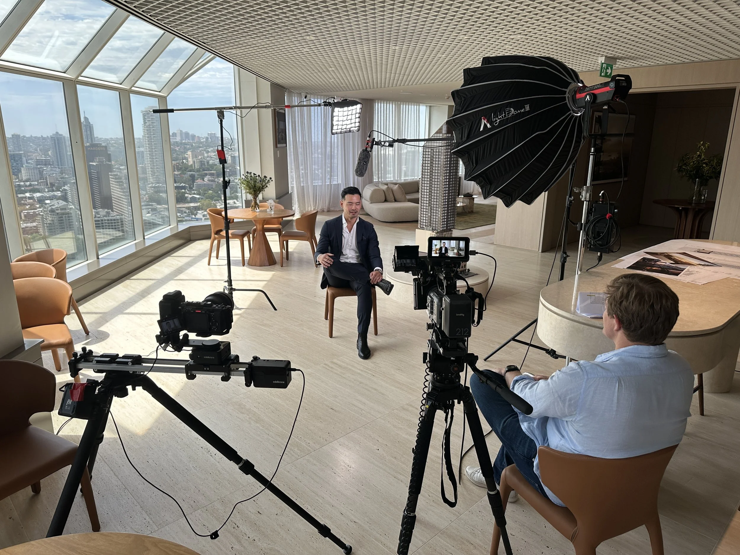 Camera operator filming corporate video in Sydney with professional lighting setup