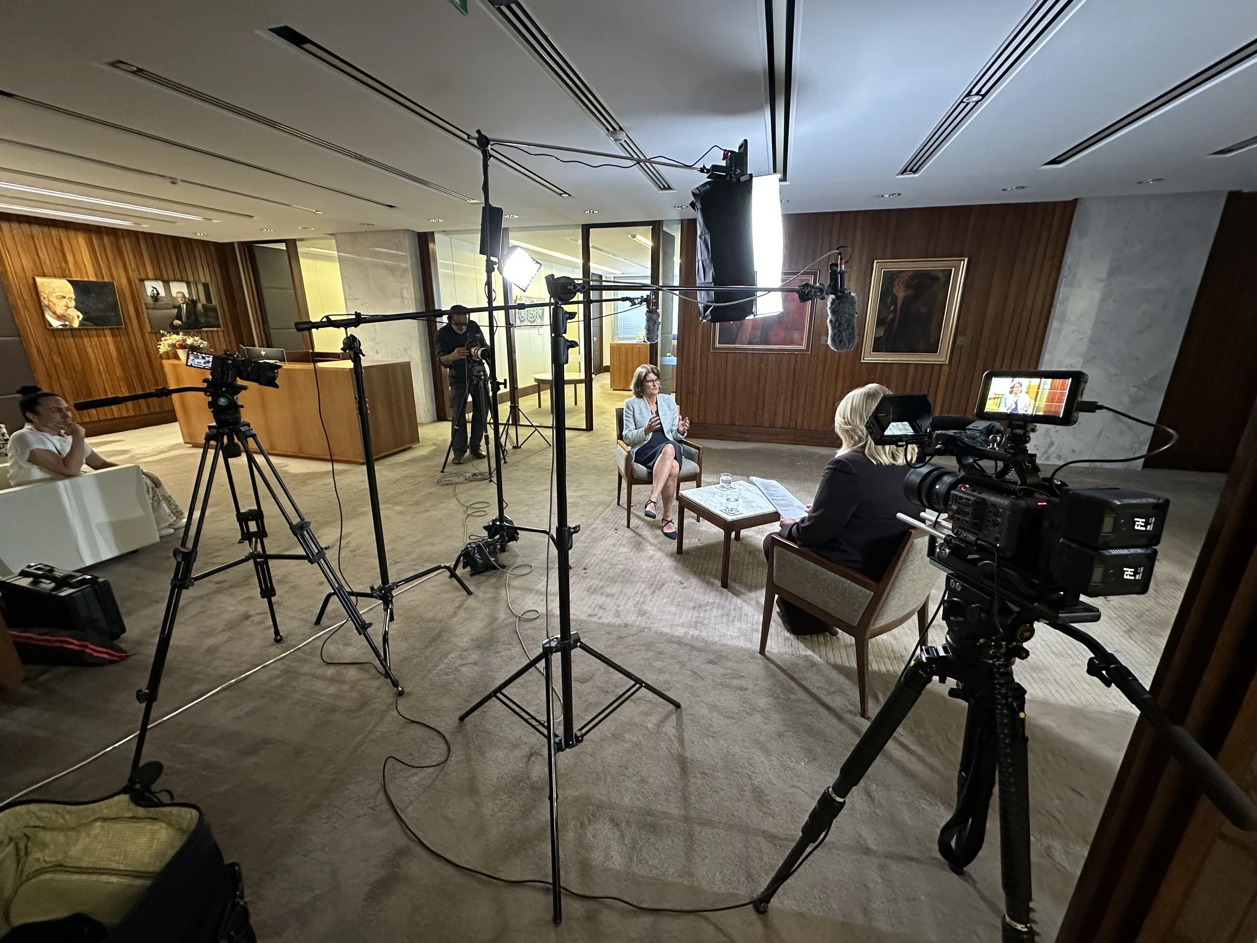 Camera operator filming corporate video in Sydney with professional lighting setup