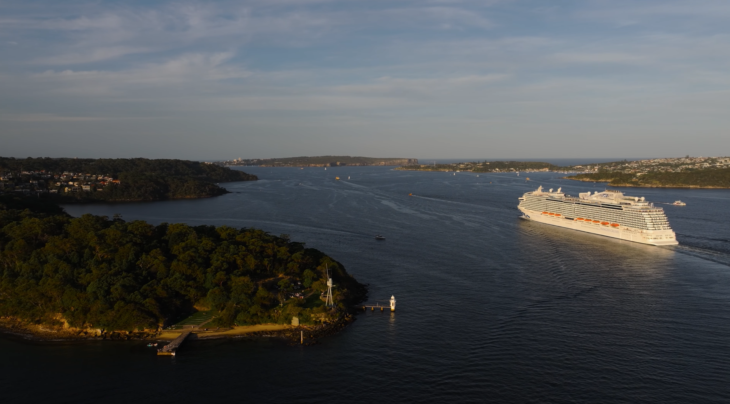 Cinematic drone aerial shot of Sydney Harbour with water and coastline filmed by drone operator