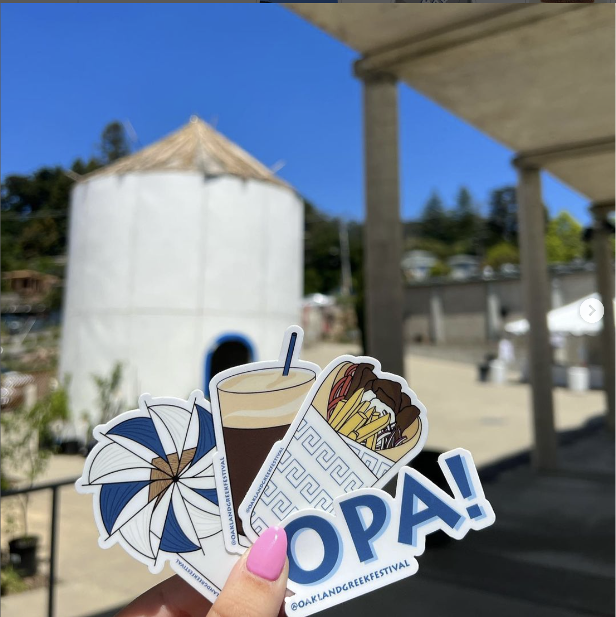 Four Oakland Greek Festival stickers in front of windmill