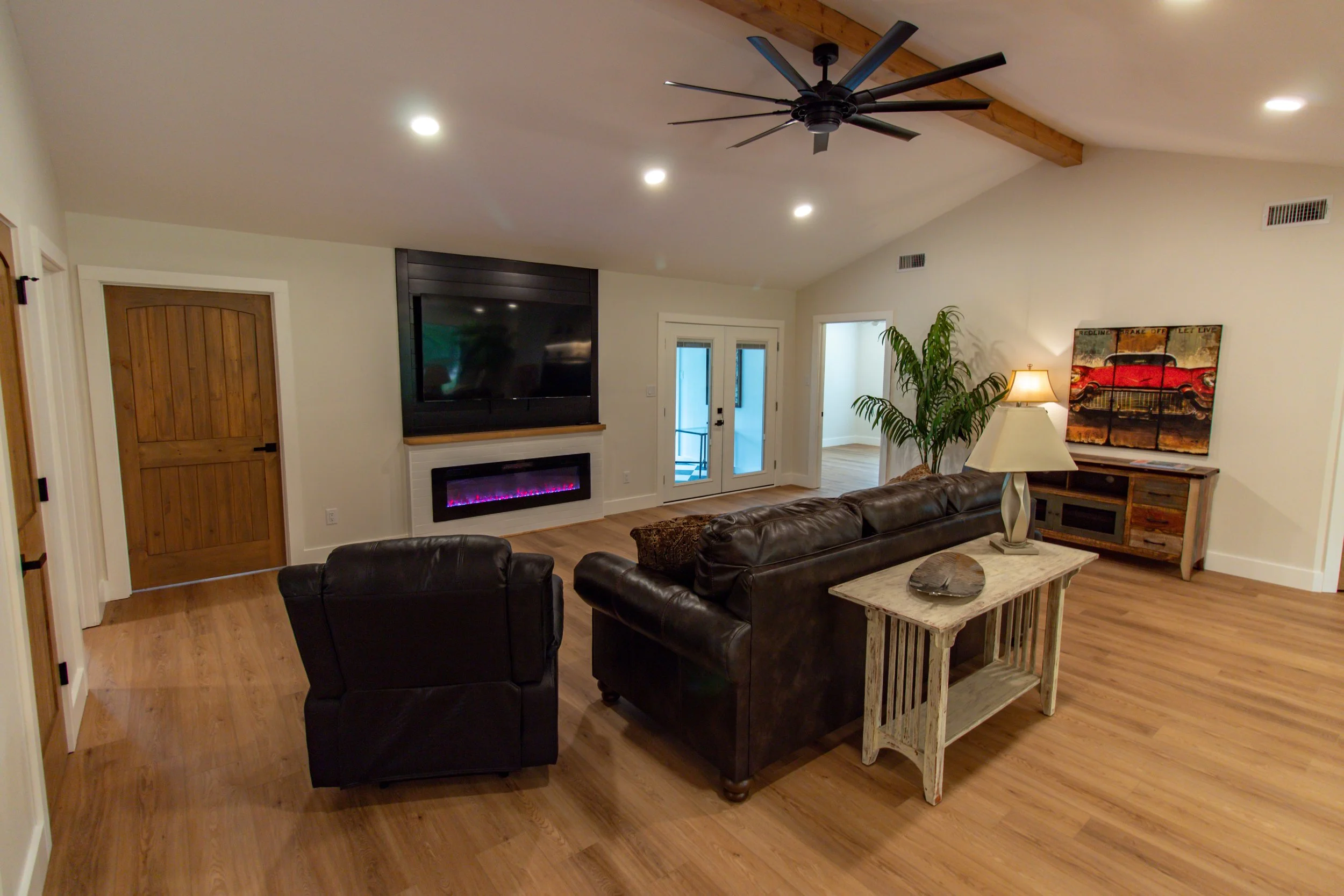 [Living room.]

Enjoy endless entertainment seated near an electric fireplace while watching your favorite programs on our 70" smart TV.