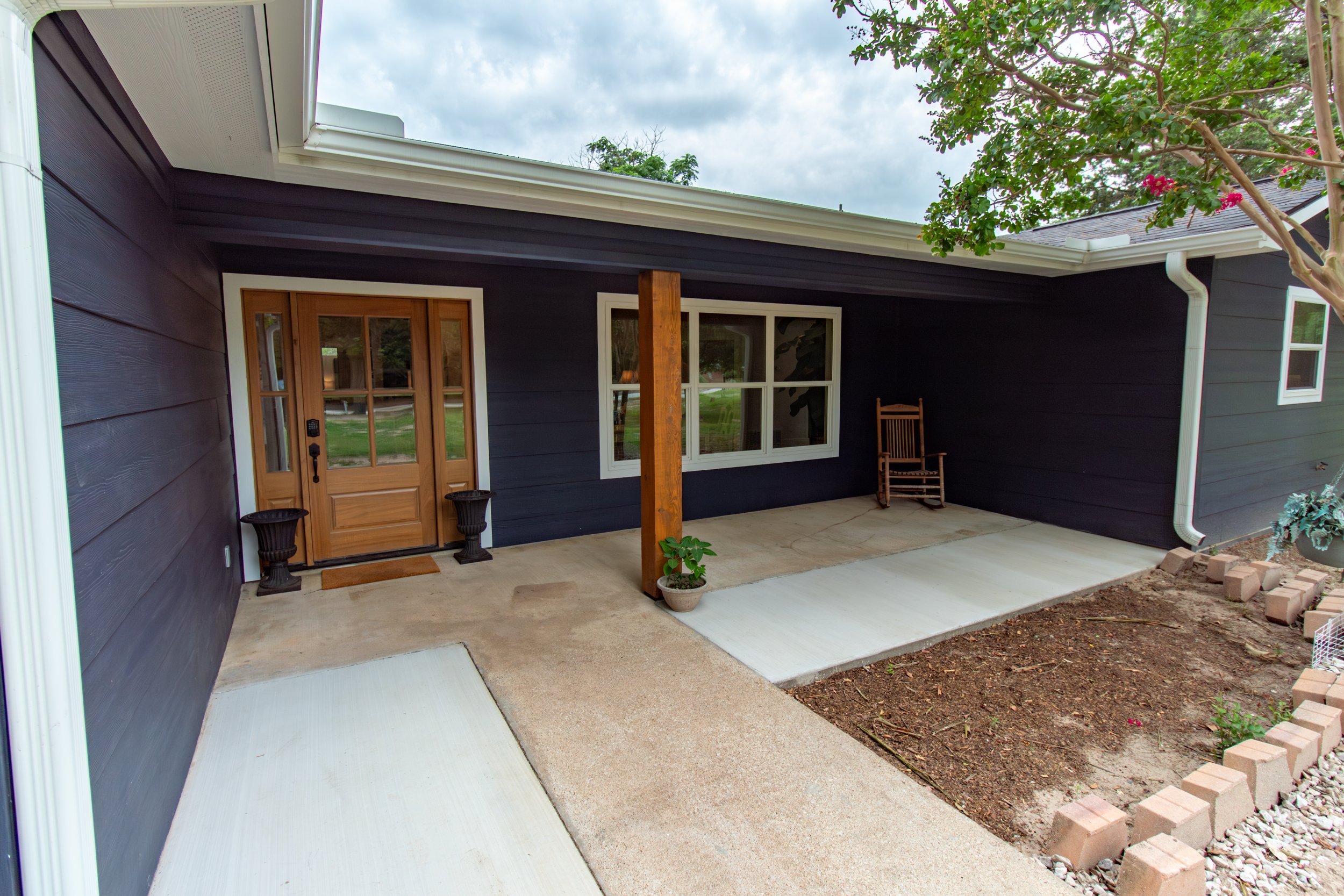 [Walkway and main entry door view, from driveway.]

Our wheelchair accessible front porch is perfect for quiet mornings accompanied by a cup of coffee.