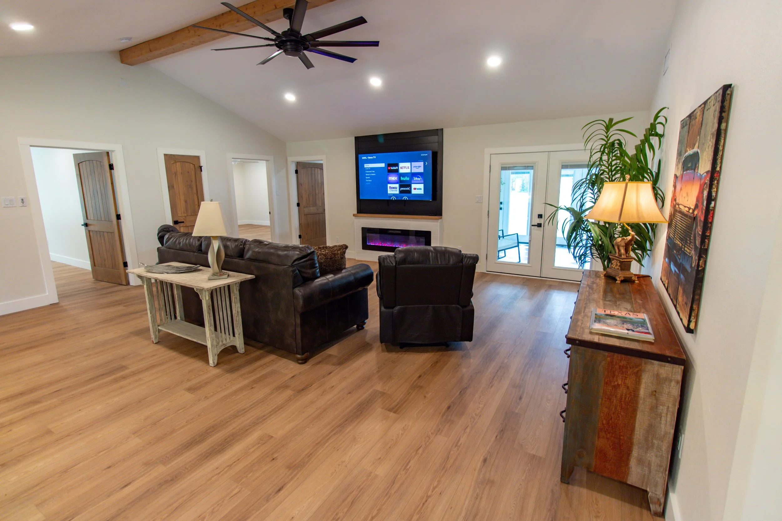 [Living room view with doorway to sunroom, from breakfast nook and kitchen.]