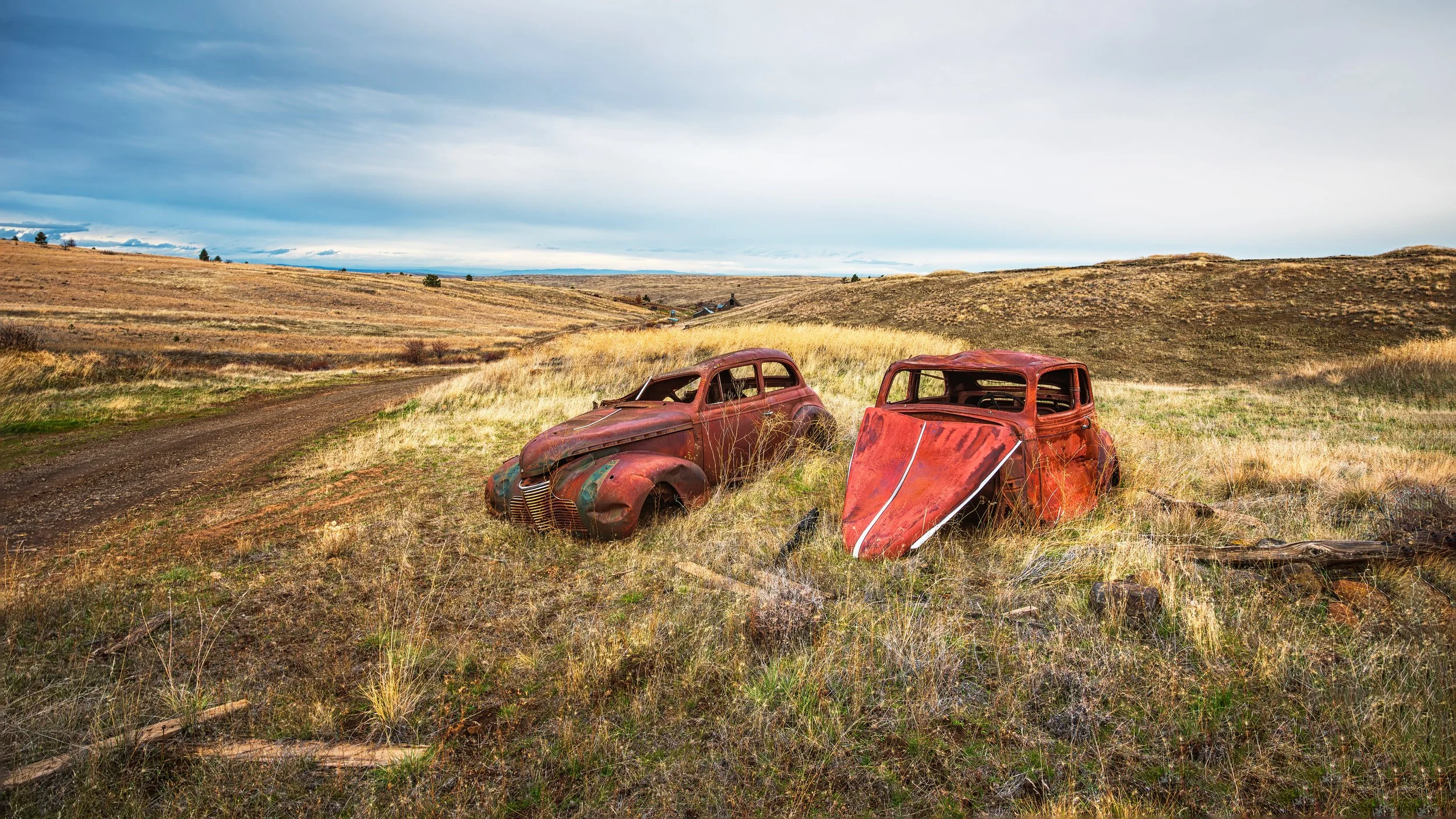 These are two old cars parked along the road on the way to Nansenes Dance Hall.